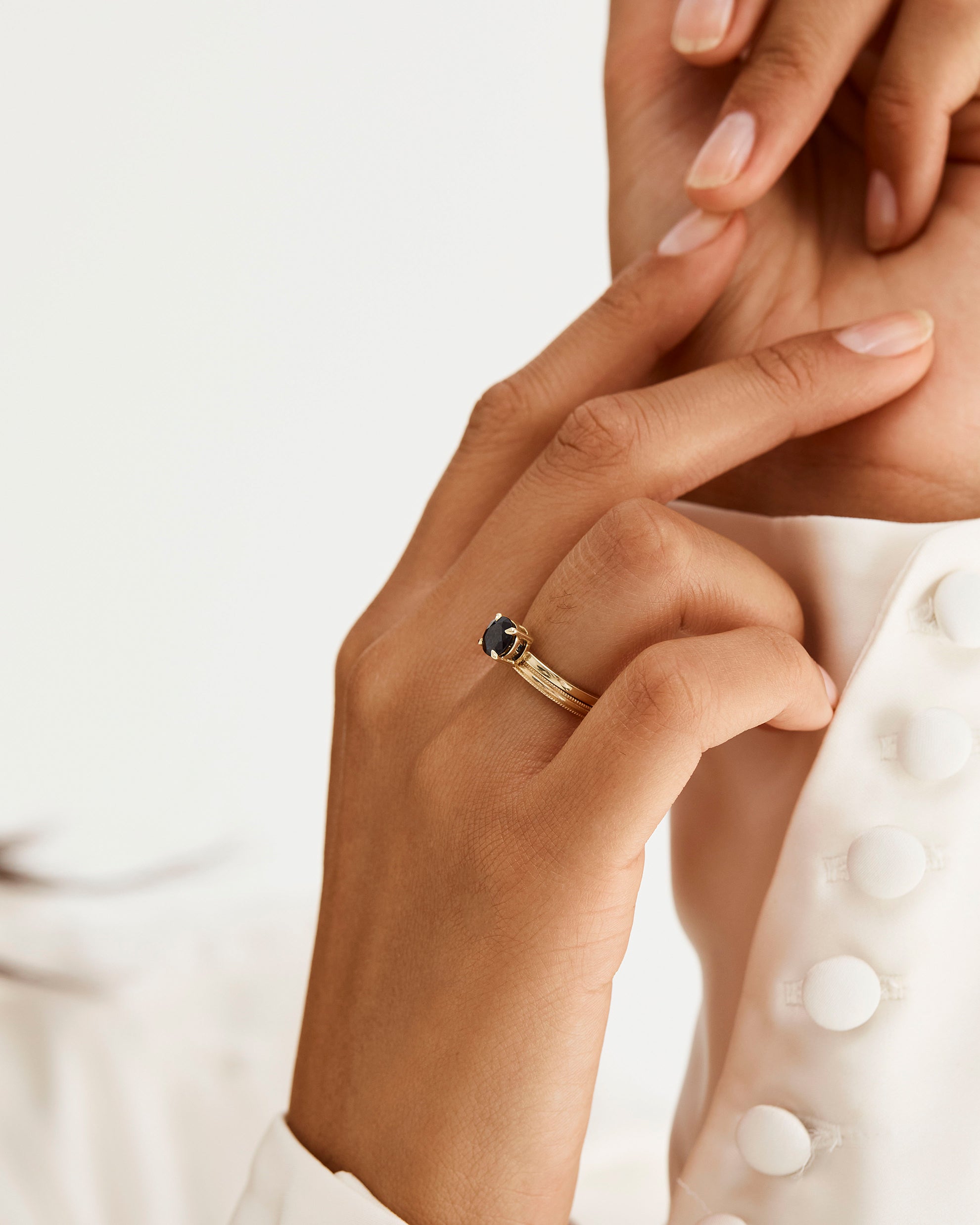 A millgrain detailed band in 2mm, stacked with a sapphire solitaire