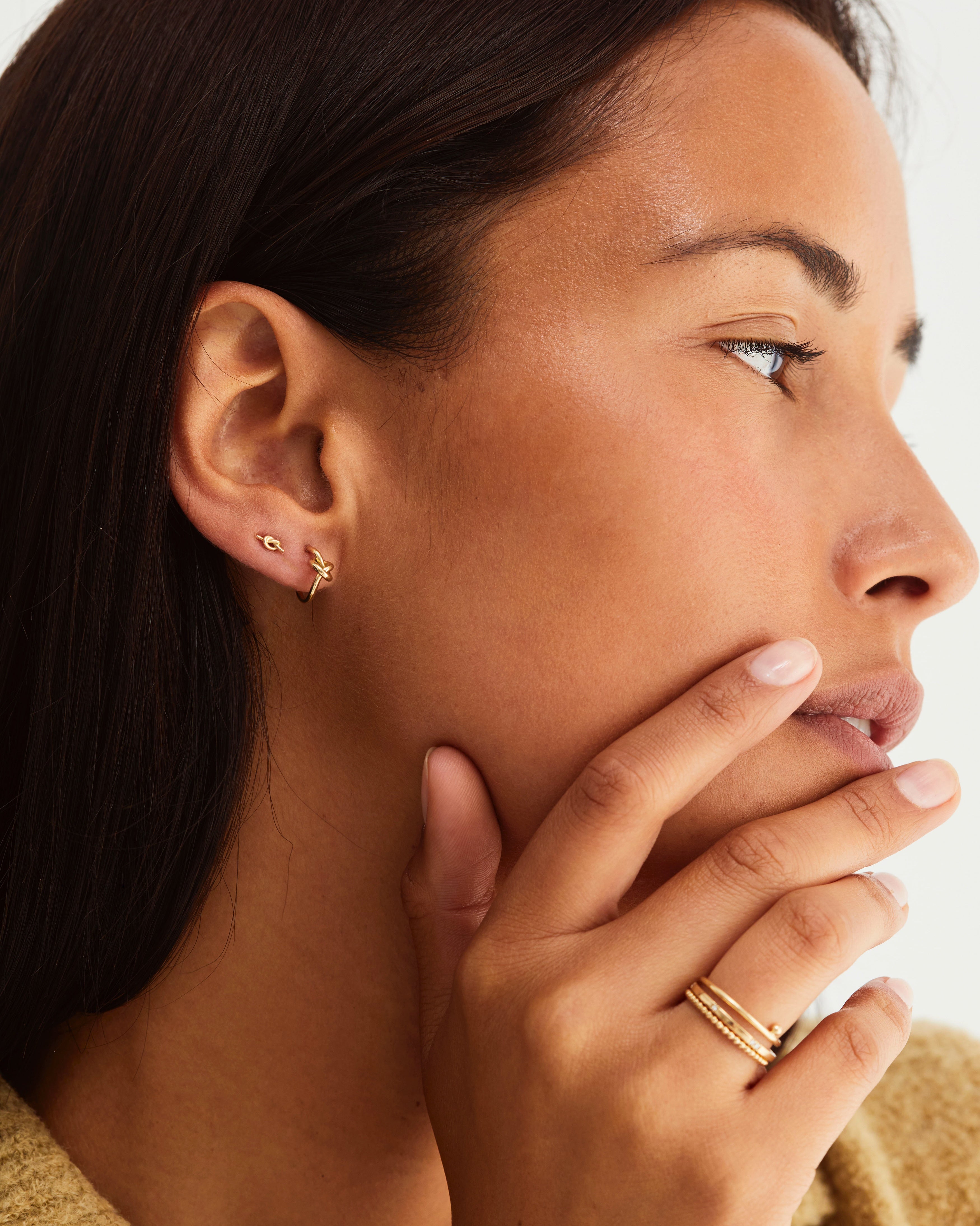 A close up an on an earring stack featuring a Cara Stud and the Dà anam Hoops.