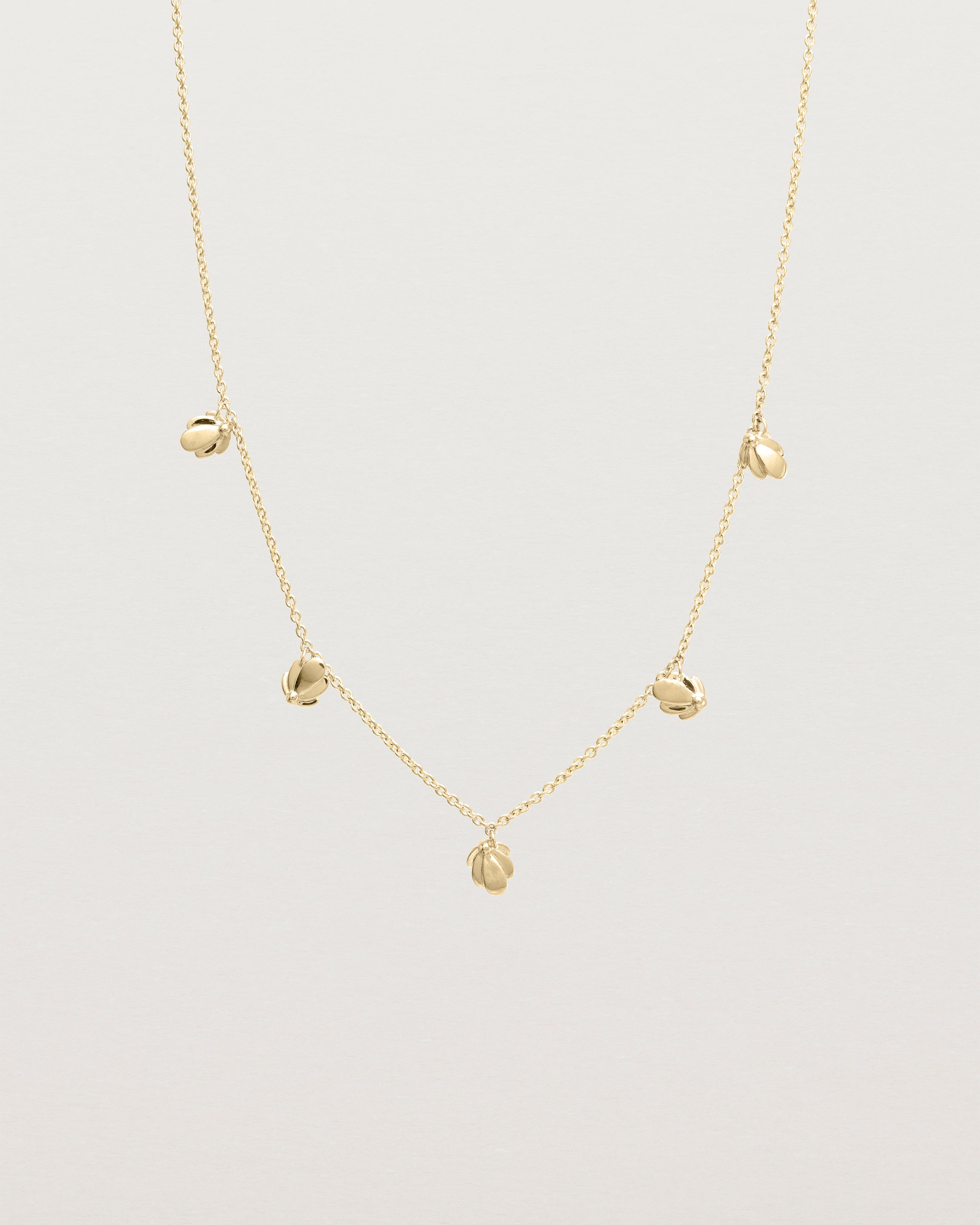 Front view of the Aeris Charm Necklace in yellow gold.