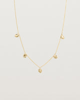 Front view of the Aeris Charm Necklace in yellow gold.