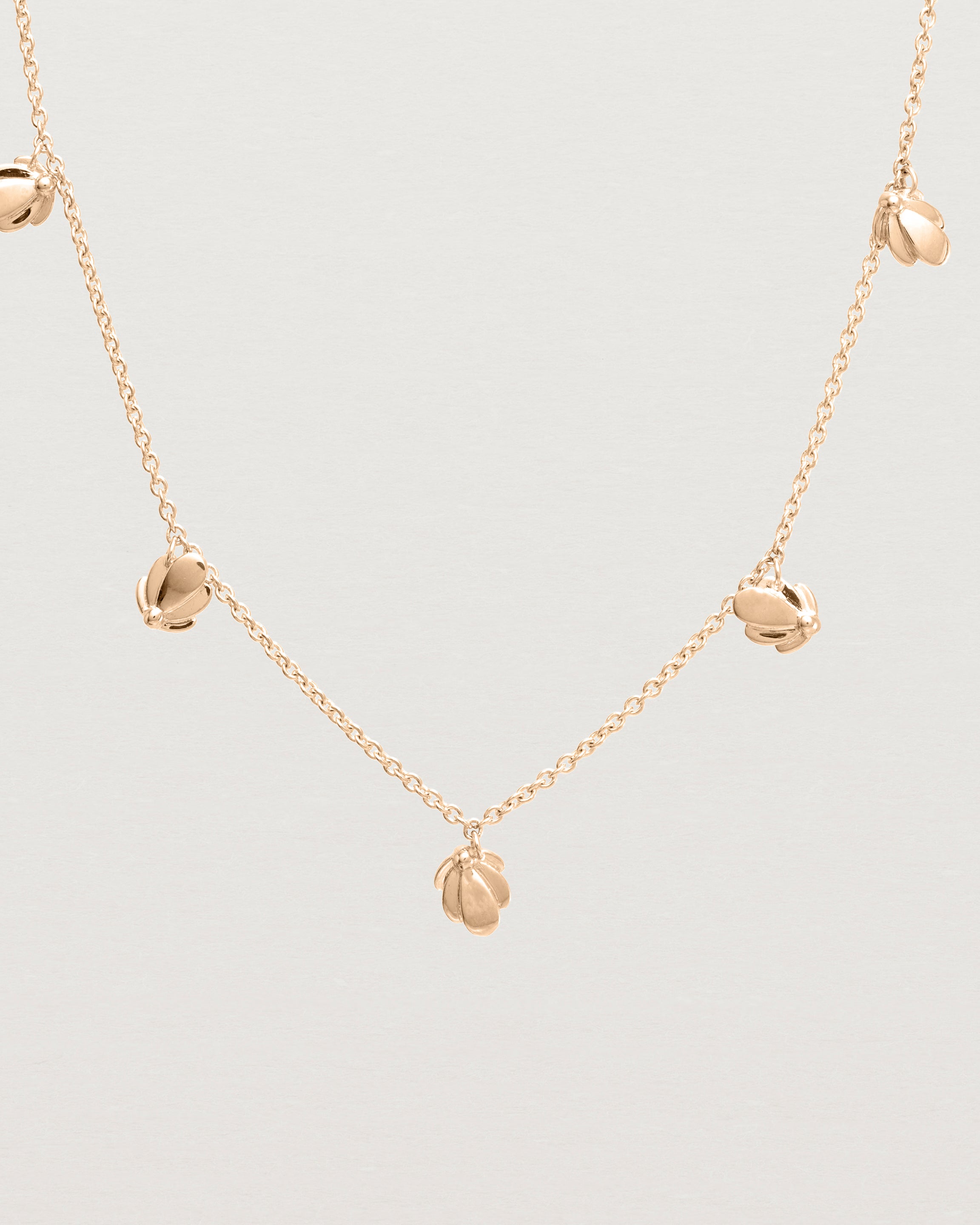 Close up view of the Aeris Charm Necklace in Rose Gold.