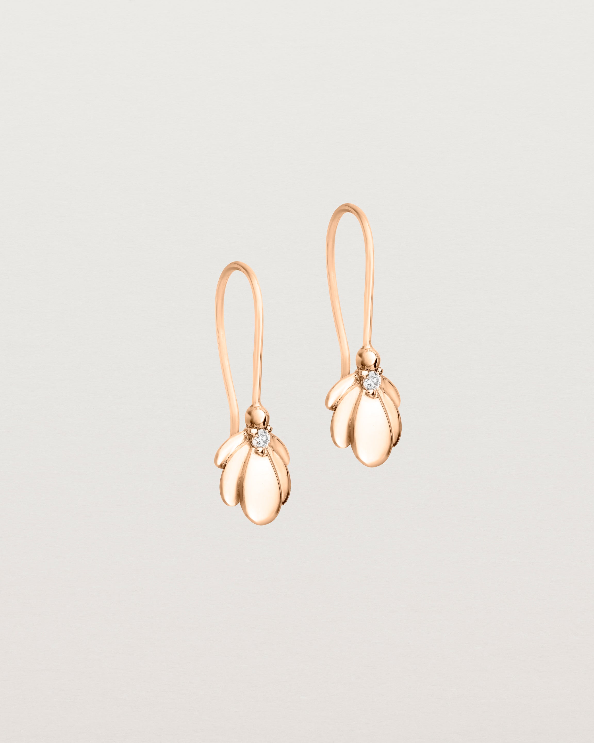 Angled view of the Aeris Earrings | Diamond | Rose Gold.