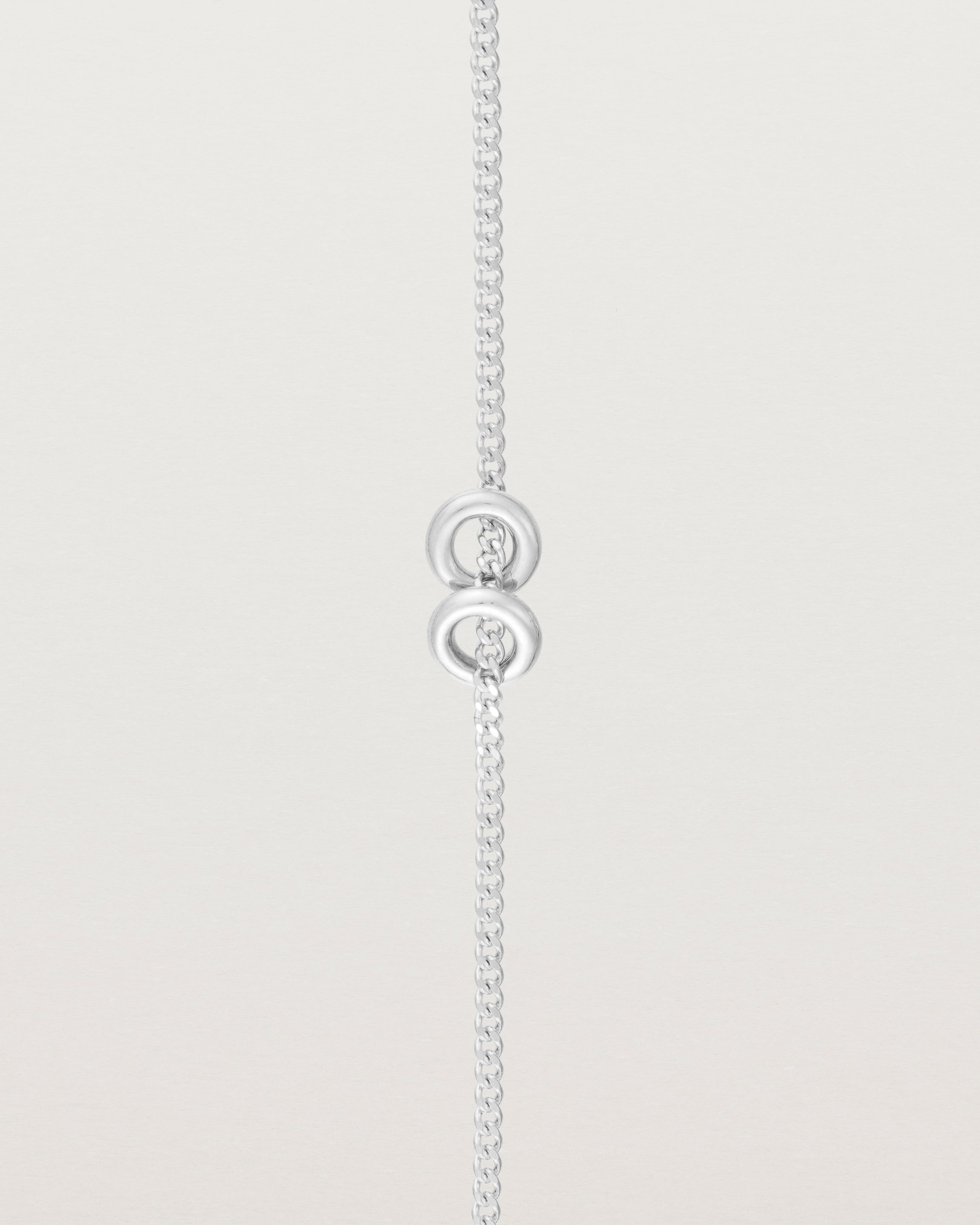 close up view of the Aether Bracelet showing two round charm in sterling silver
