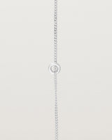 close up view of the Aether Bracelet showing one round charm in sterling silver