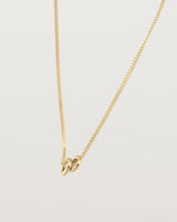 Aether necklace showing two round charms in yellow gold