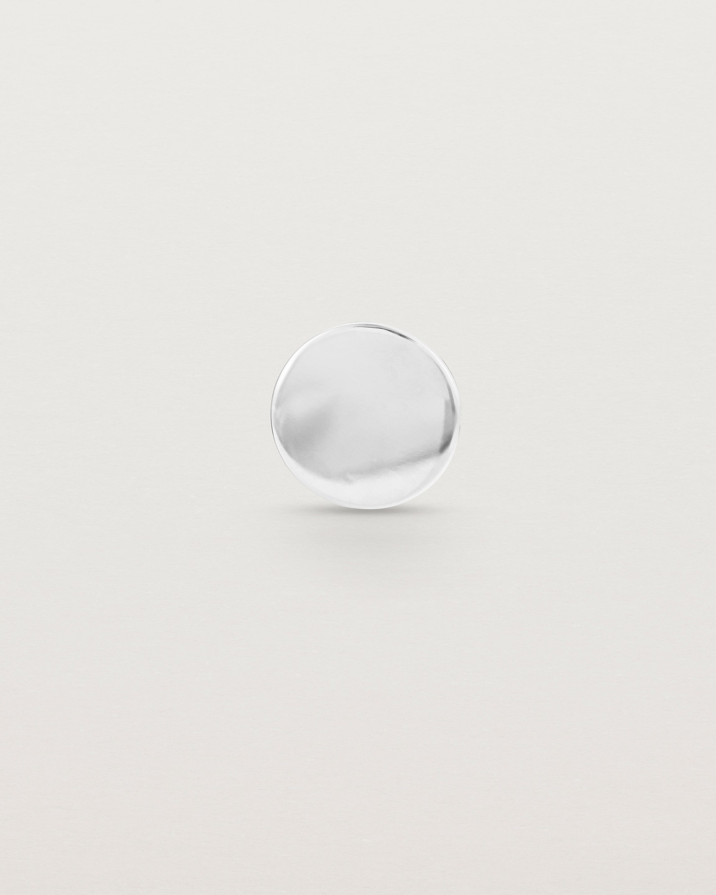 A round sterling silver lapel pin