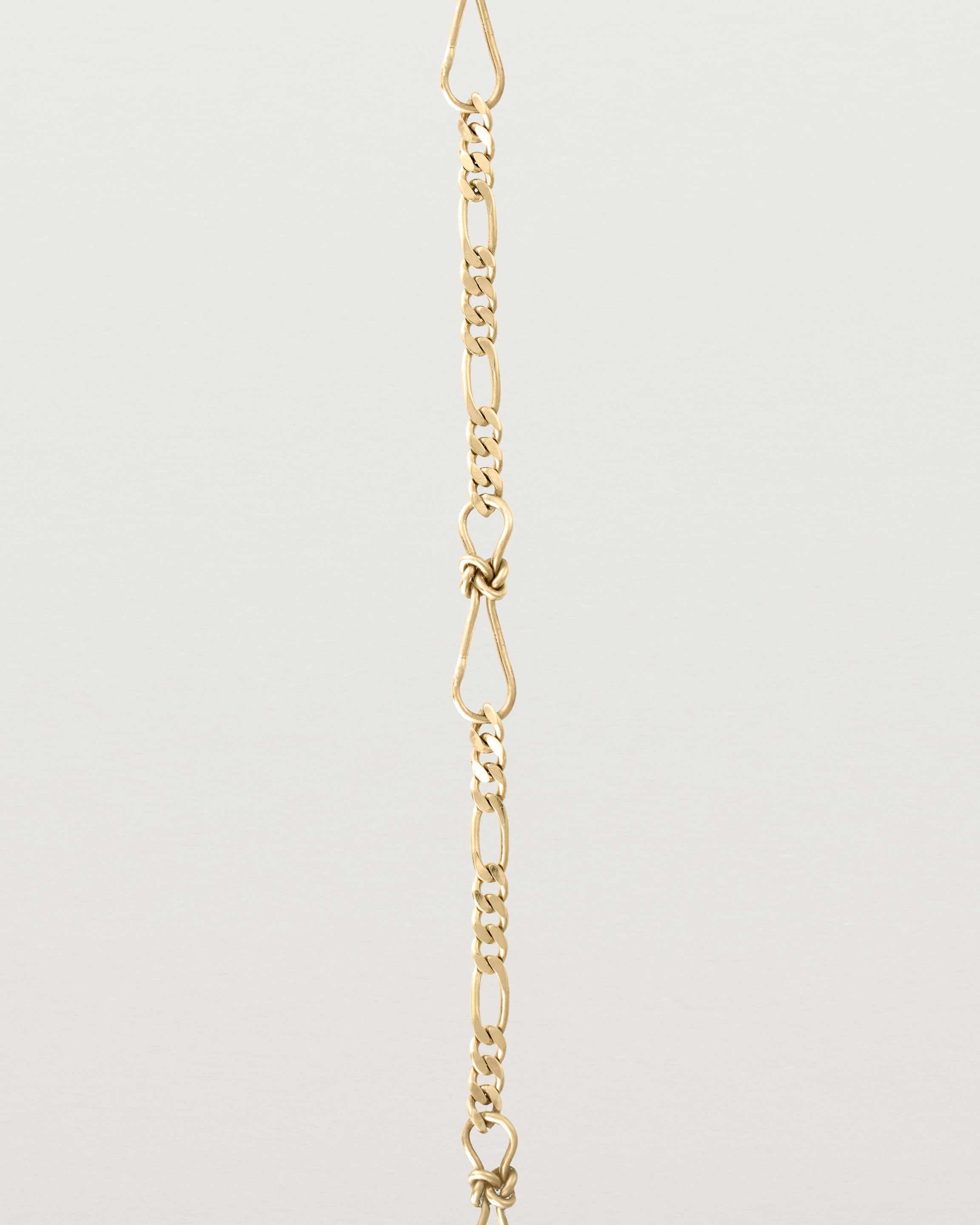 A close up of the Anam Charm Bracelet in yellow gold.