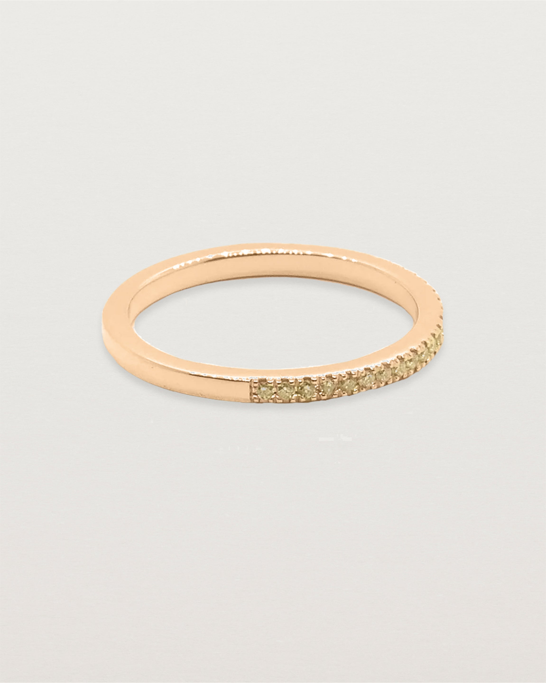 A half band of champagne diamonds set in a rose gold band
