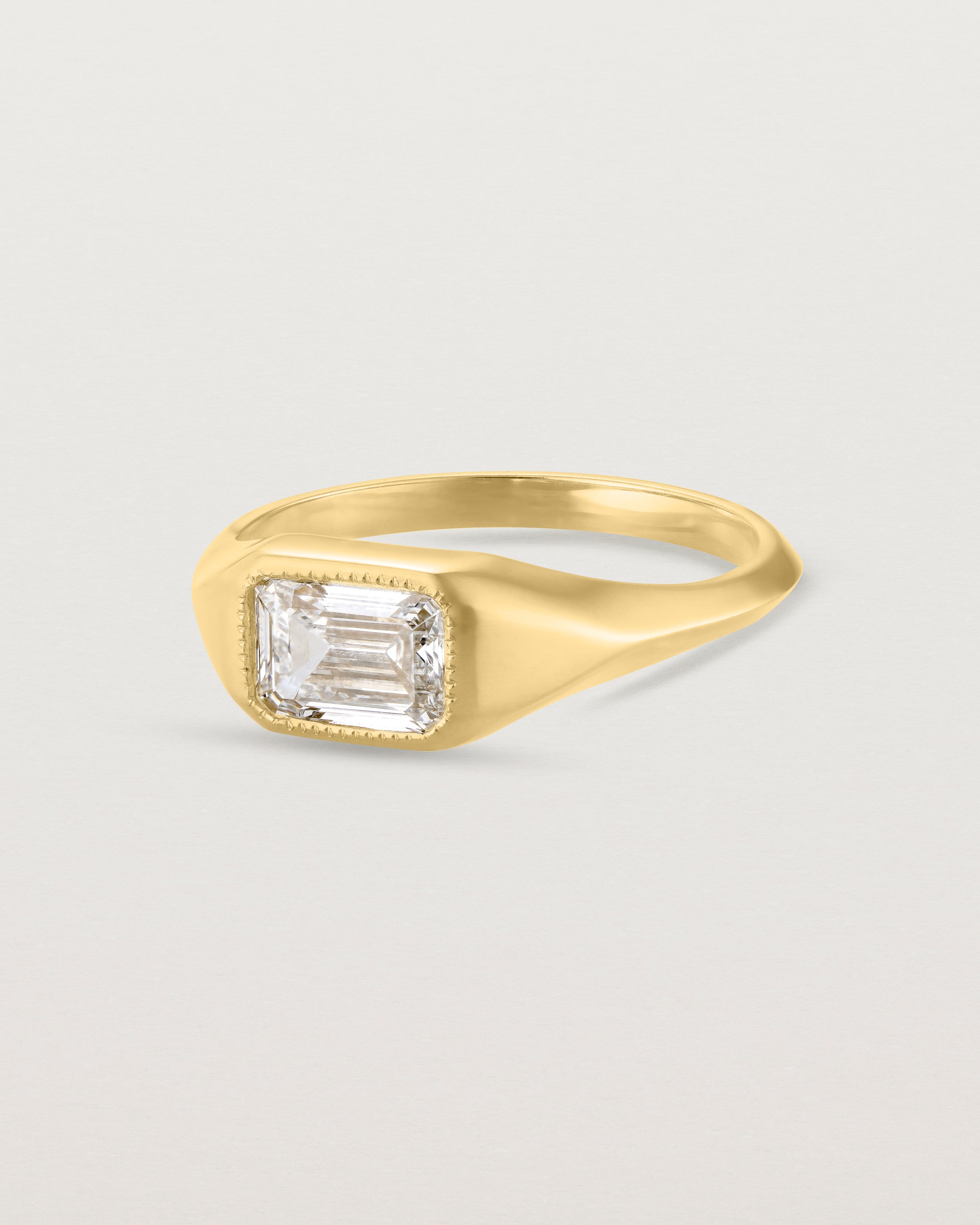 Angled view of the Átlas Emerald Signet | Laboratory Grown Diamond in yellow gold with a polished finish. 