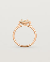 Standing view pear halo ring featuring a pear cut clear laboratory grown diamond and a halo of white diamonds in rose gold