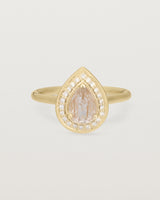 Front view pear halo ring featuring a pear cut rutilated quartz stone and a halo of white diamonds in yellow gold