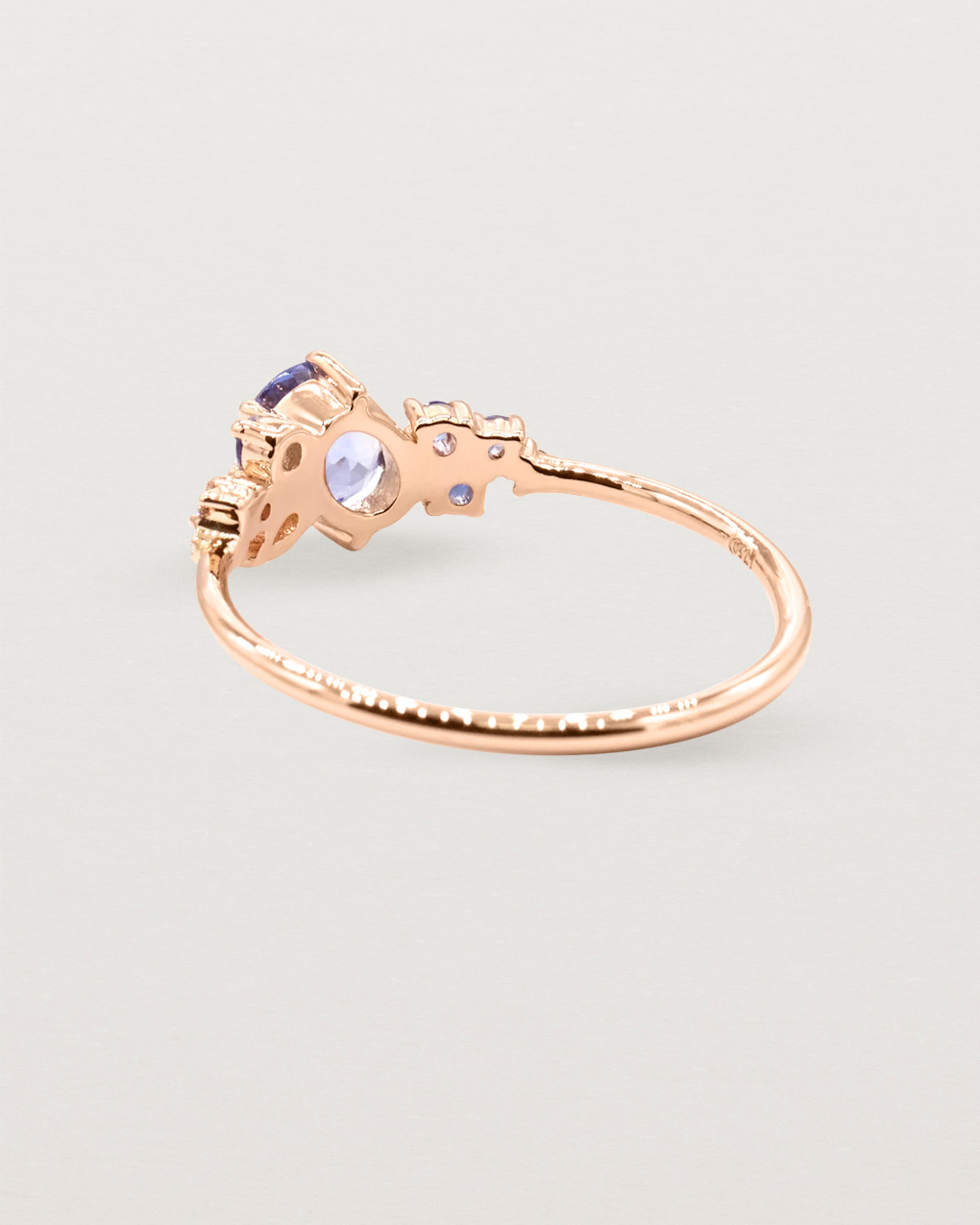 Blue sapphire cluster featuring oval and round sapphires, crafted in rose gold