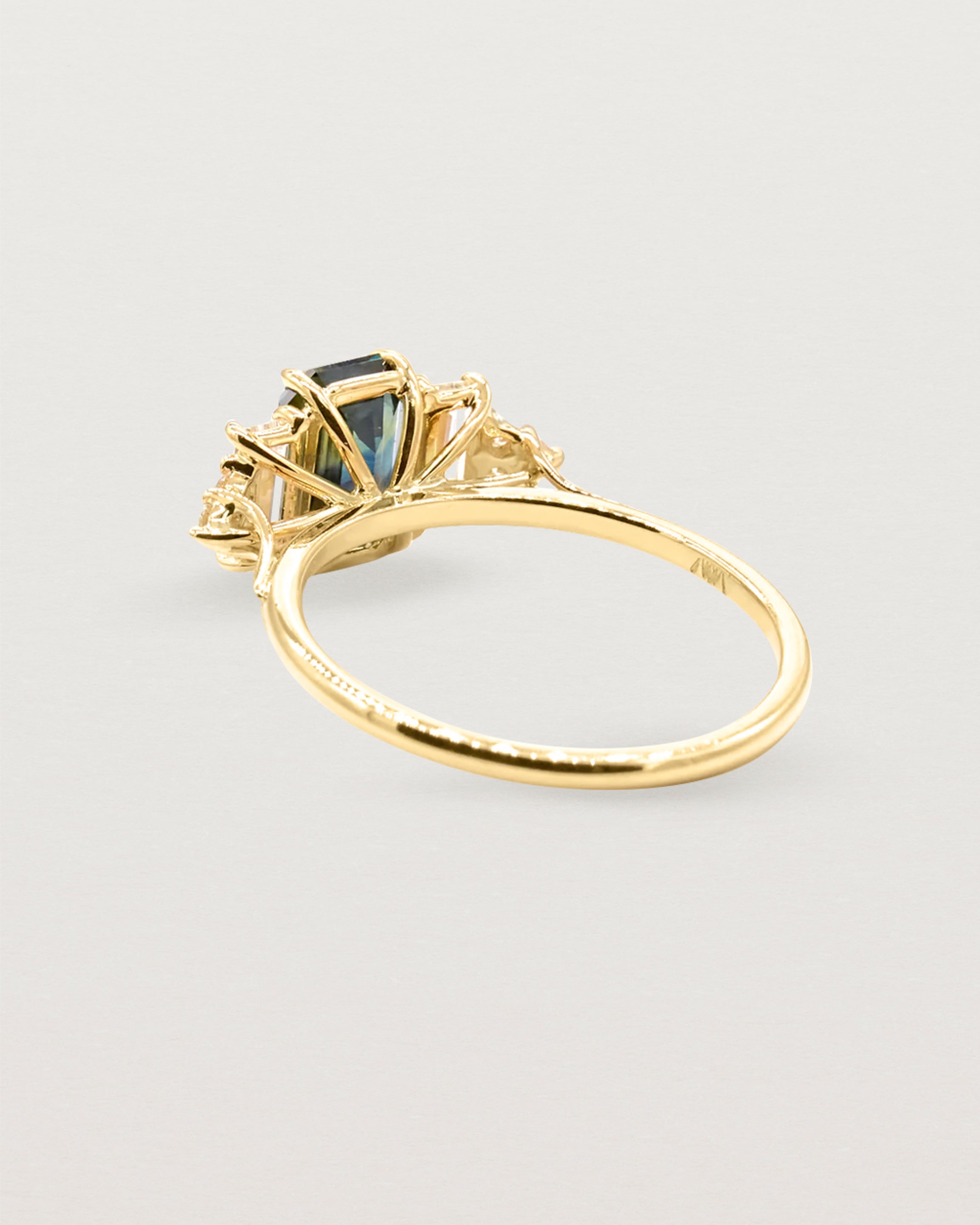 Back view of a cluster ring set in yellow gold
