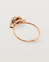 The back view of a rose gold cluster ring
