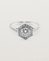 A hexagonal halo diamond ring featuring a central 0.32 carat round cut diamond and surrounded by a diamond halo.