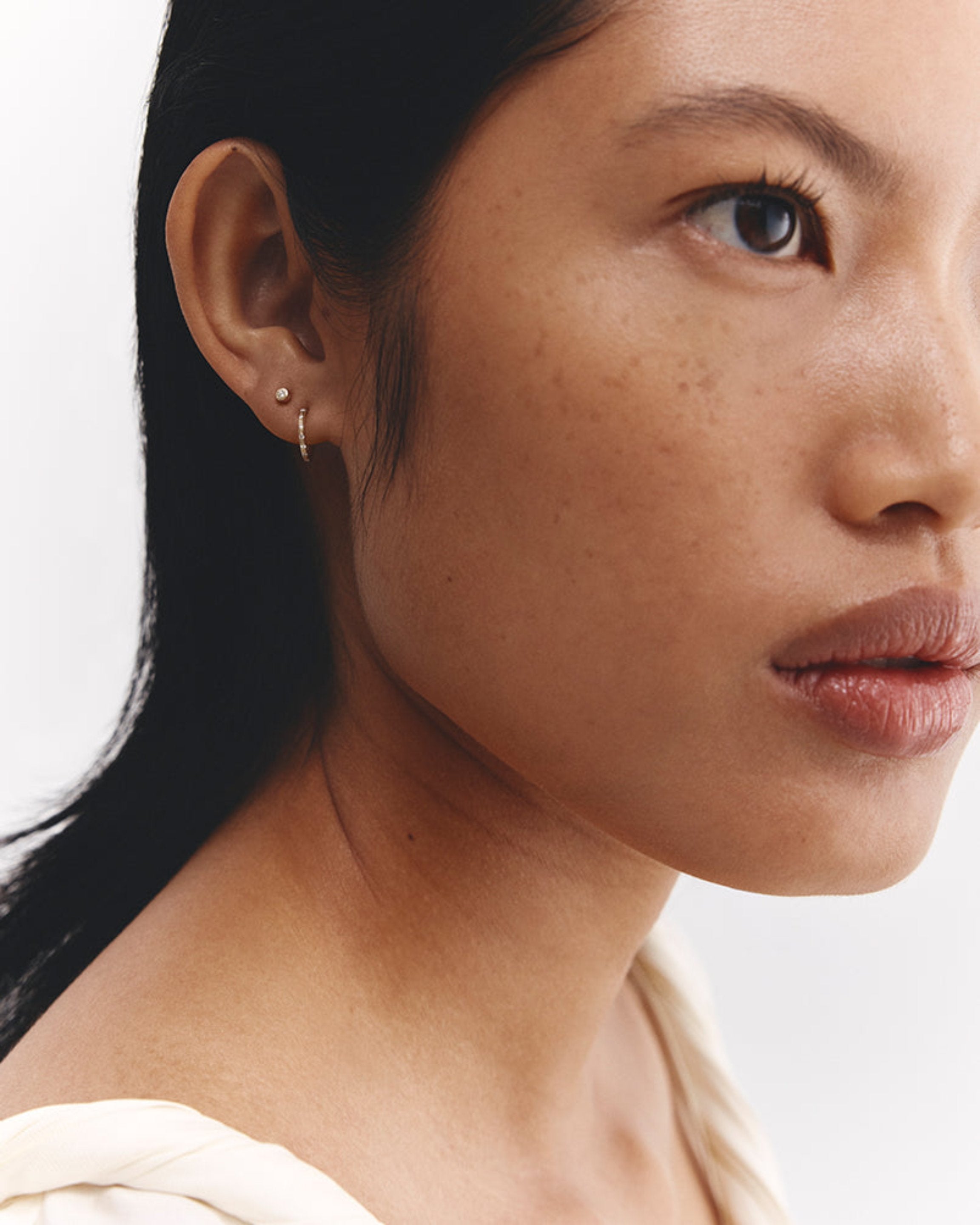 Model wears diamond Cascade Studs.