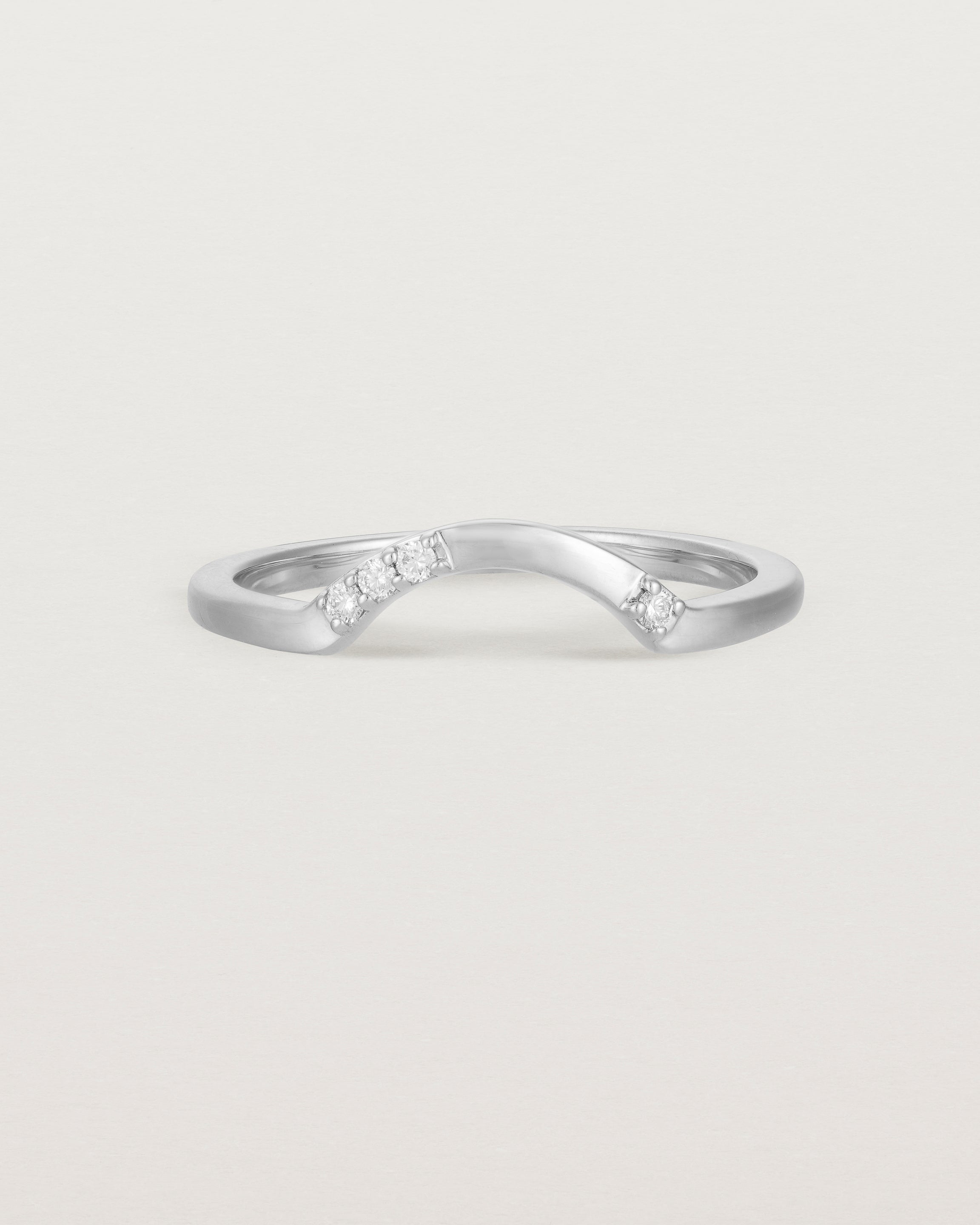 Fit three of a classic arc crown ring featuring scattered white diamonds, crafted in white gold