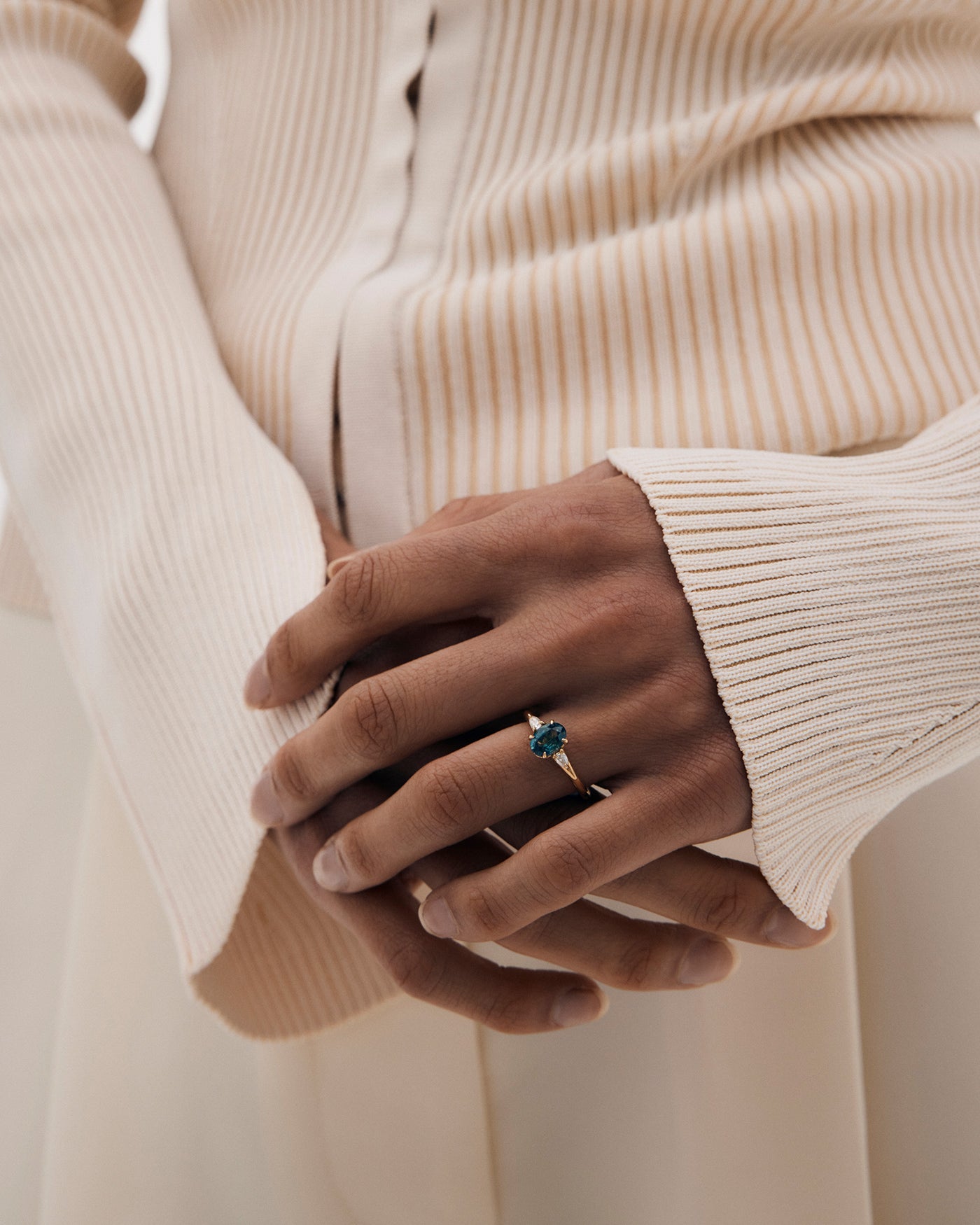 A woman wearing the Charli Sweeping Wire Trio ring