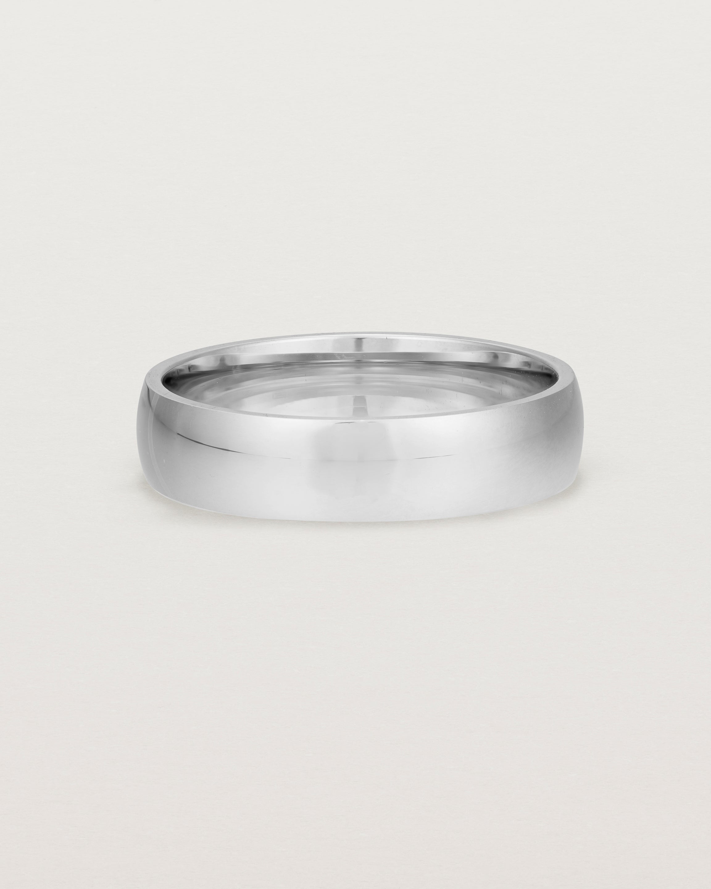 The front view of a 5mm wide heavy wedding ring in white gold.