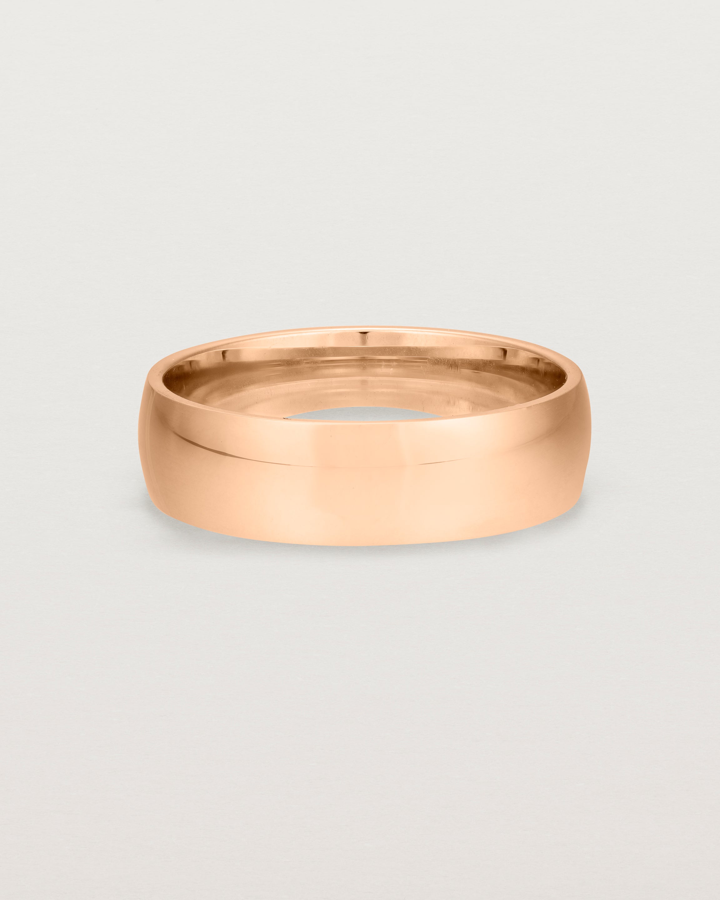 The front view of a 6mm wide heavy wedding ring in rose gold. 