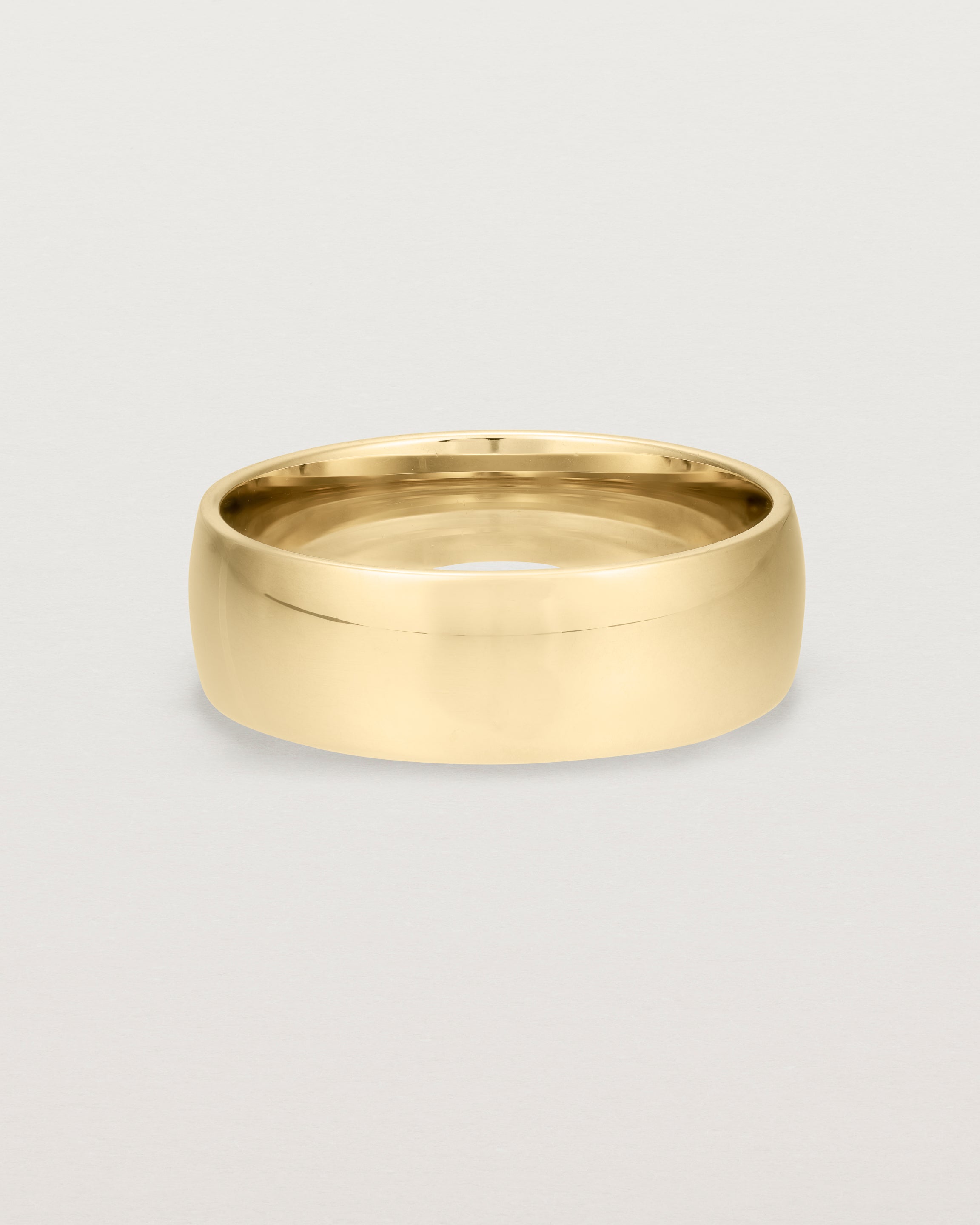 The front view of a heavy 7mm wedding band in yellow gold