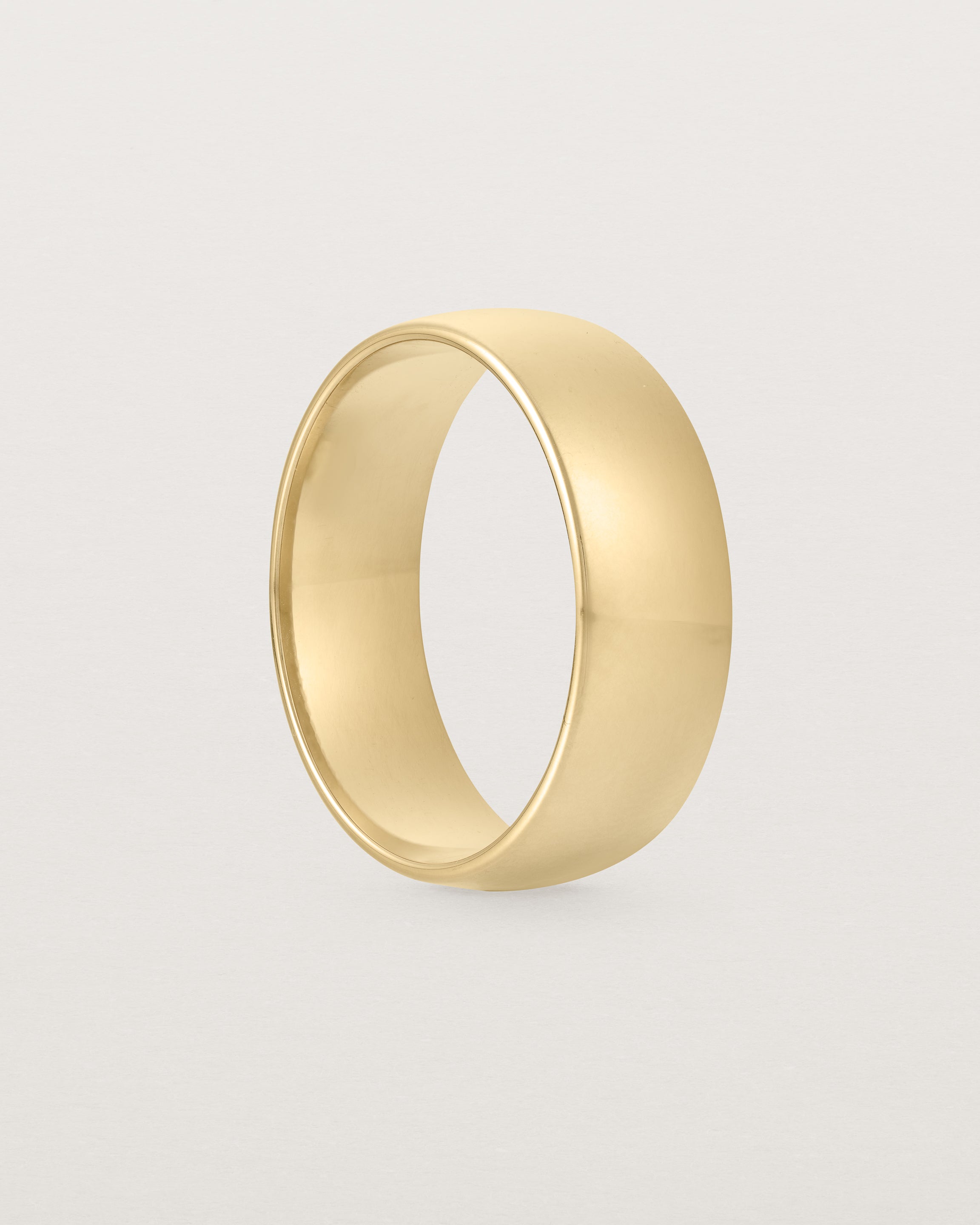 The side view of a heavy 7mm wedding band in yellow gold