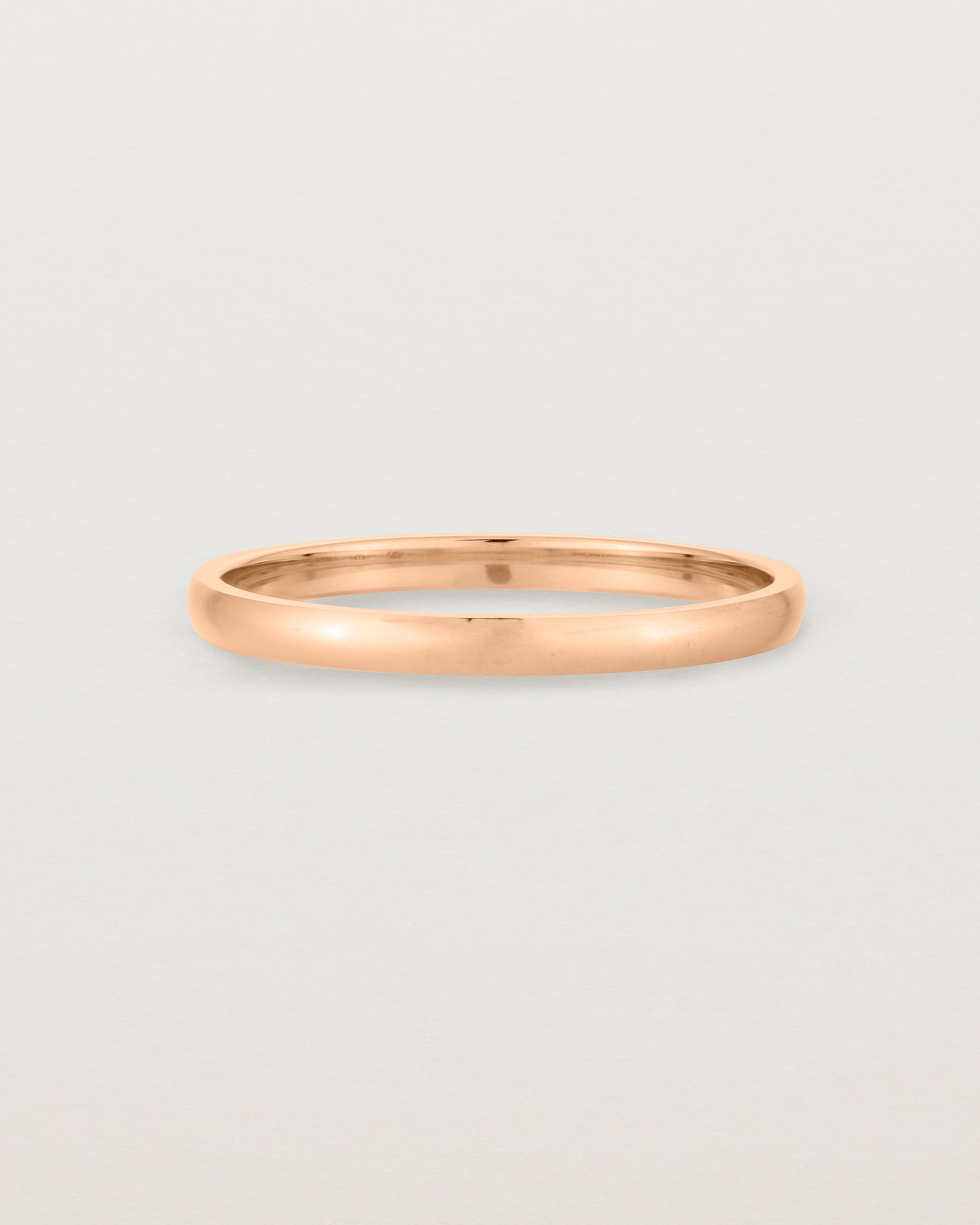 A fine, classic wedding band in rose gold