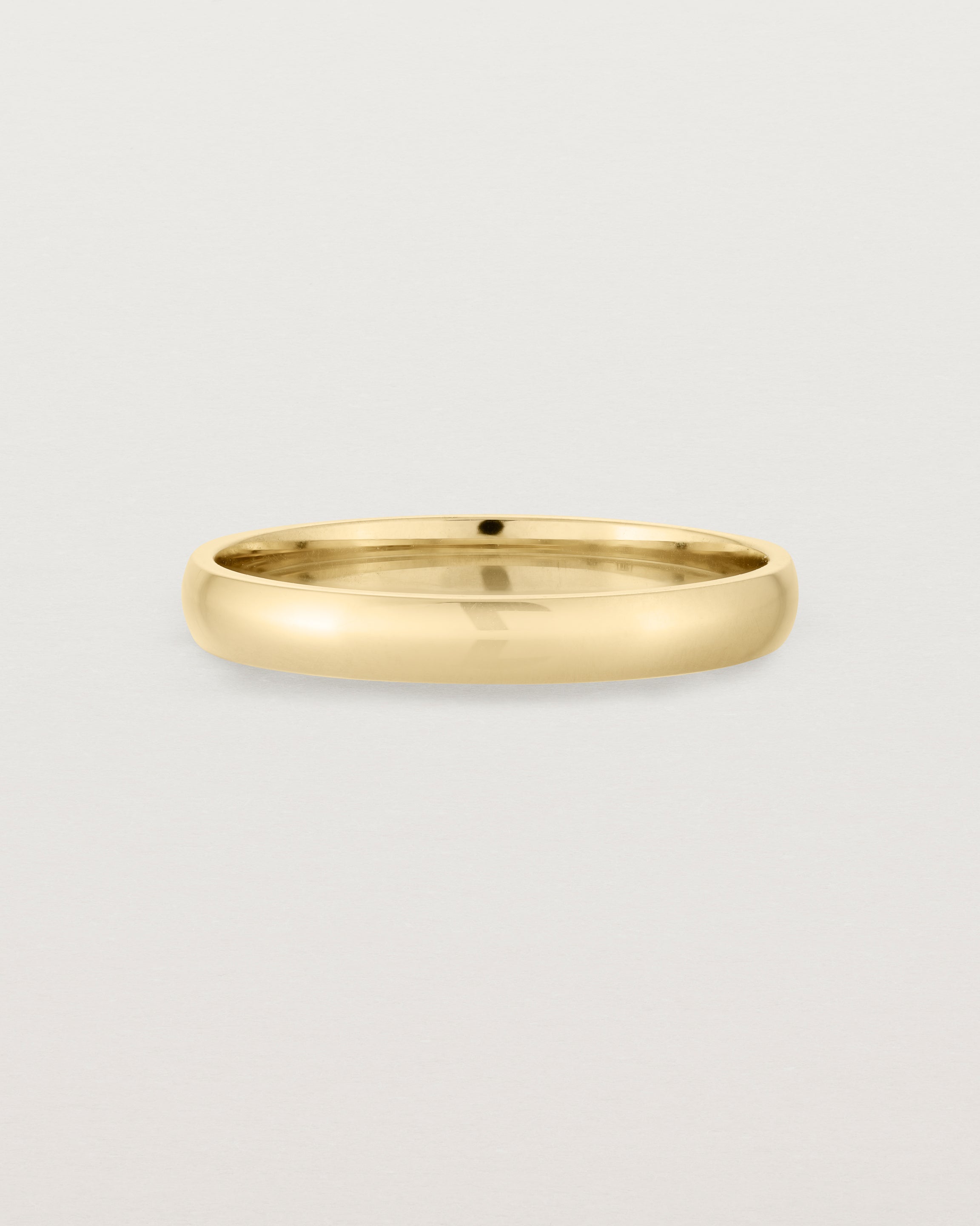 A 3mm fine, classic wedding band in yellow gold