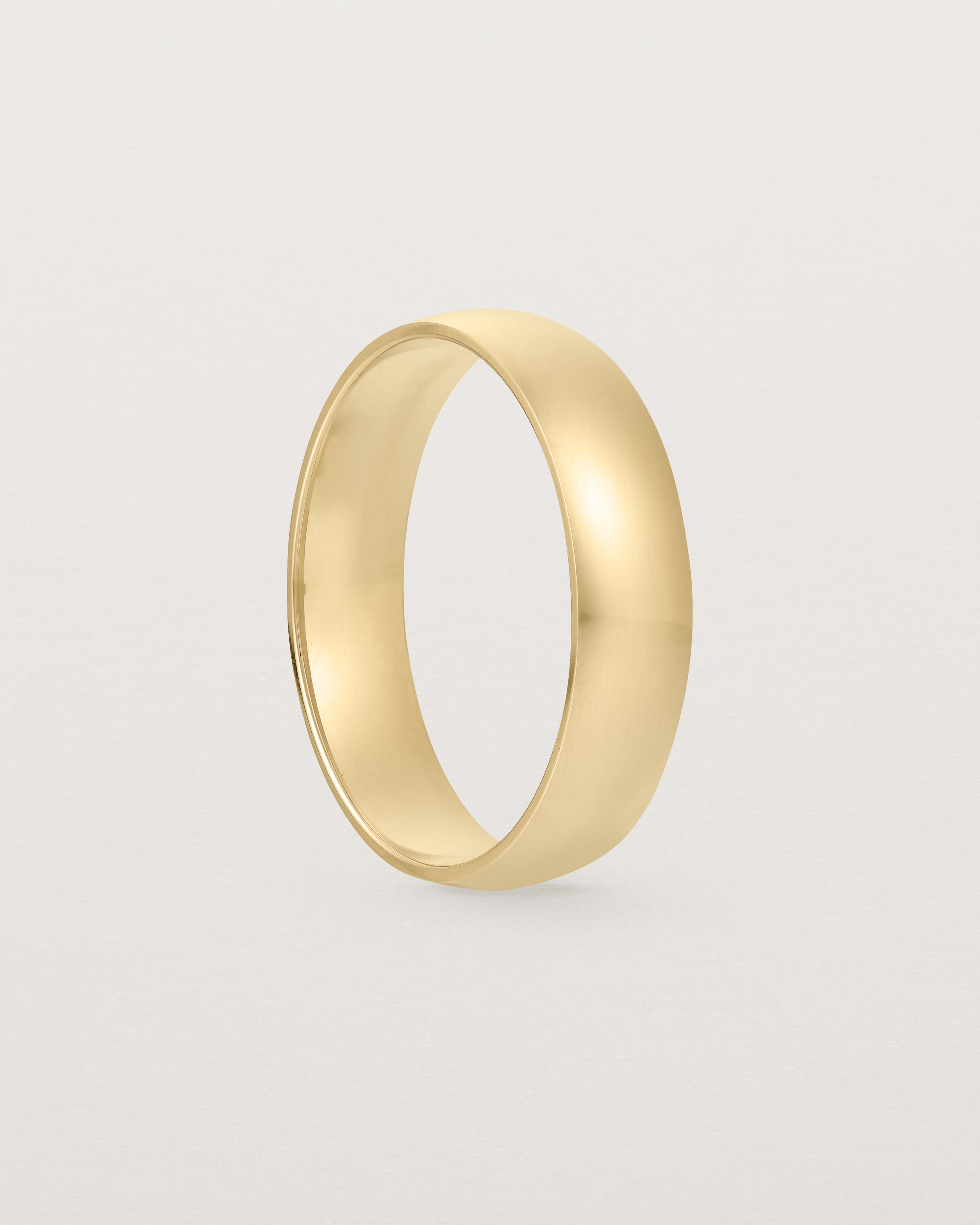 A classic 5mm wedding band, our most popular width, crafted in yellow gold