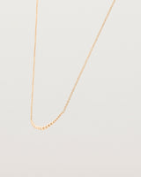 Angled view of the Crescent Necklace in Rose Gold.