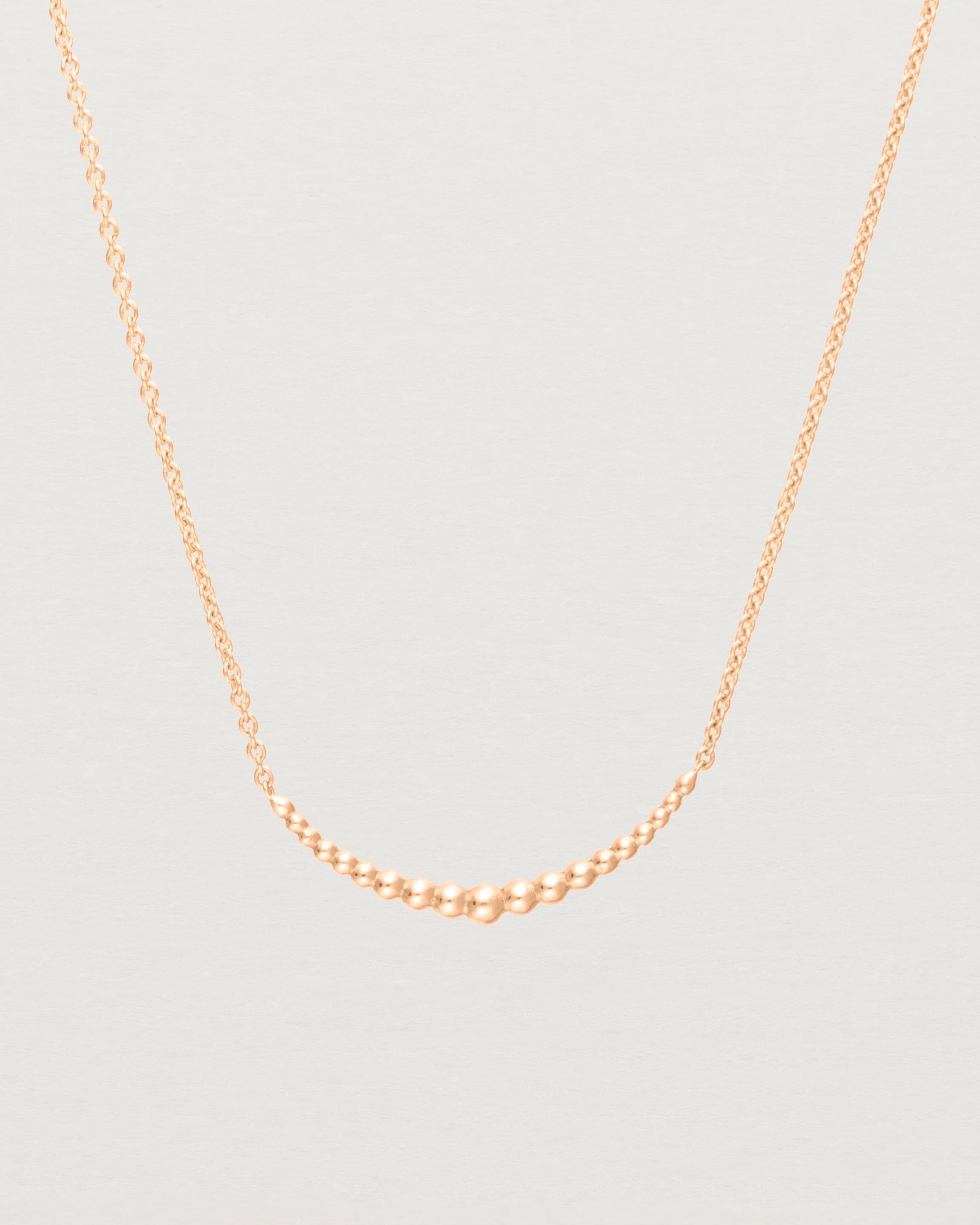 Close up view of the Crescent Necklace in Rose Gold. 