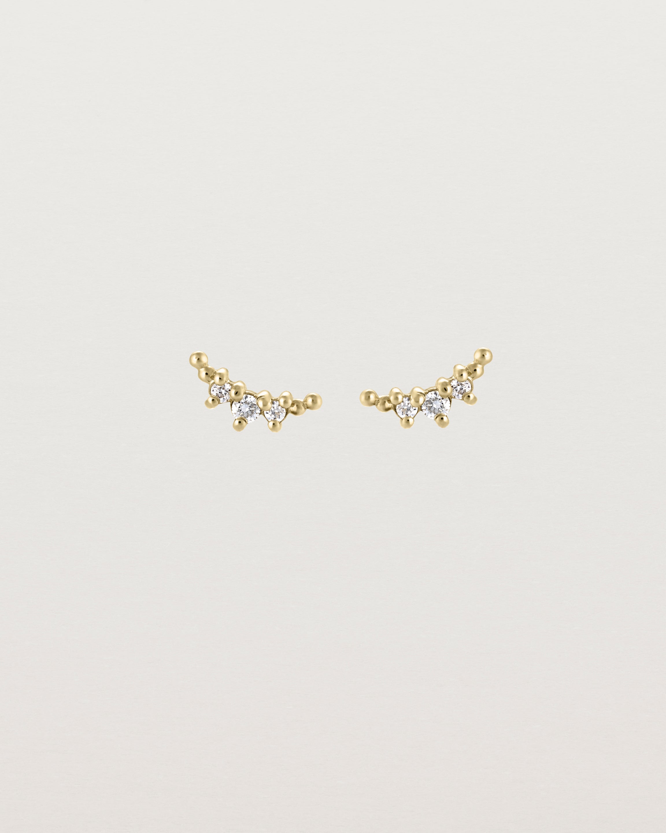 Front view of the Crescent Studs | Diamonds in yellow gold.