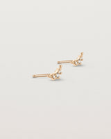 Angled view of the Crescent Studs | Diamonds in rose gold.