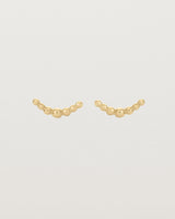 A pair of yellow gold studs featuring an arc of round metal balls