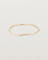 Front view of the Dalí Bangle in yellow gold