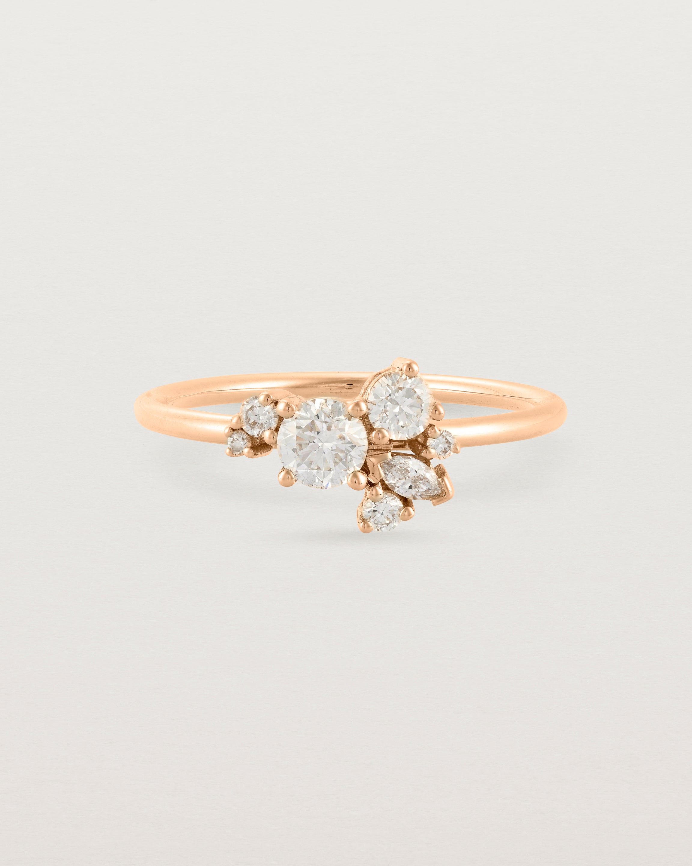 Front of a white diamond cluster ring in rose gold