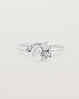 Front view of a white diamond cluster ring in white gold
