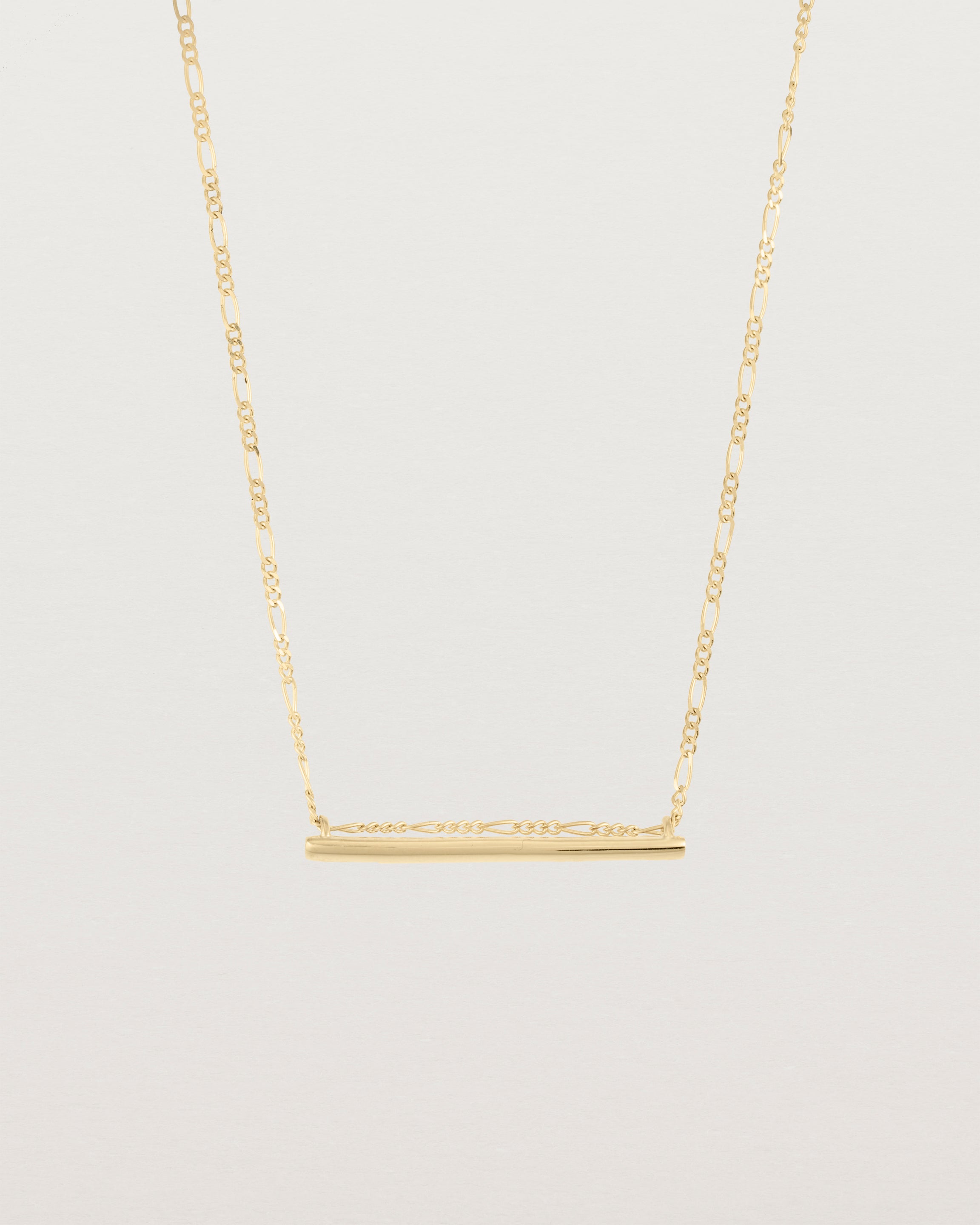 Ellipse necklace with a yellow gold bar hanging from a chain in yellow gold