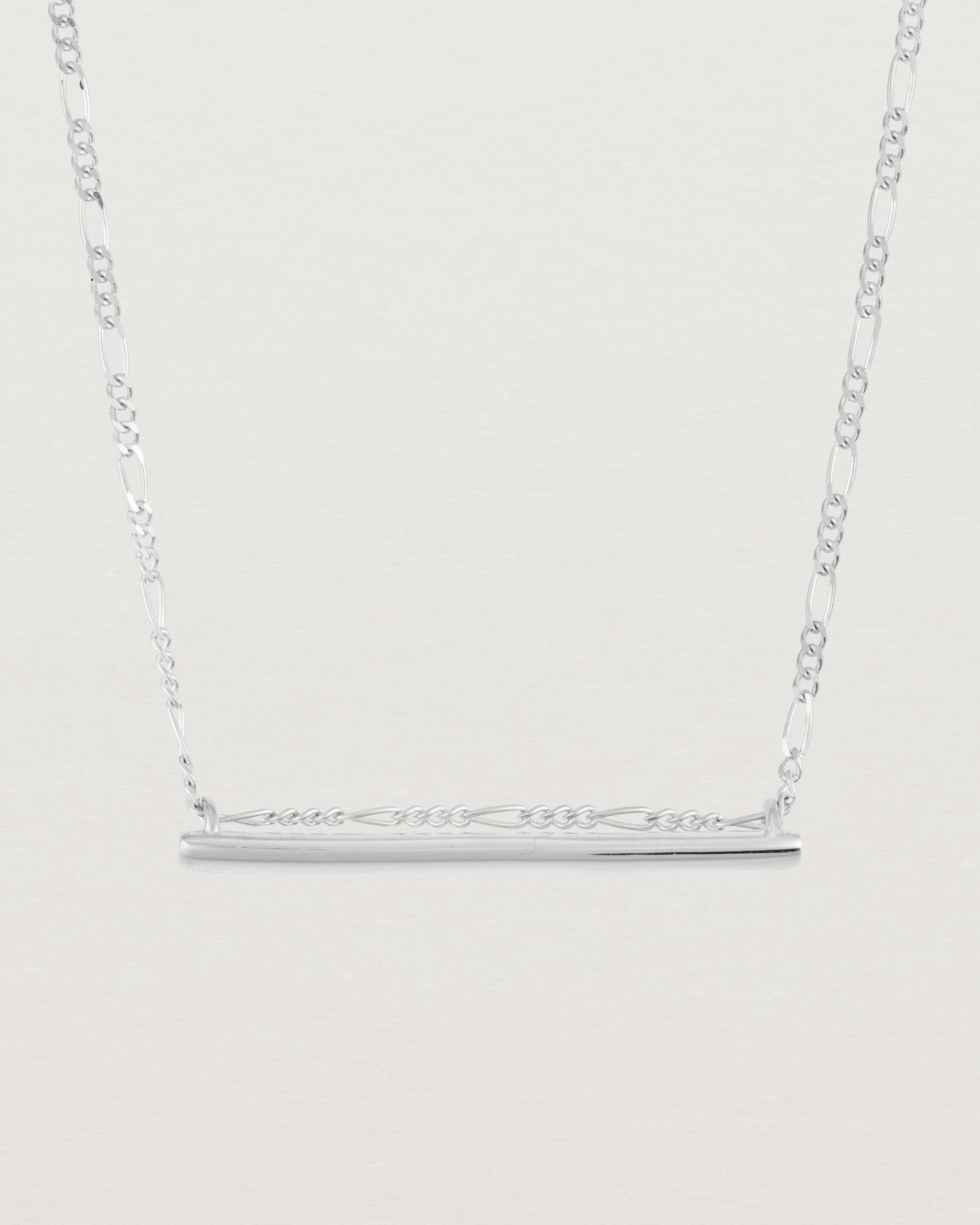 close up of Ellipse necklace with a silver bar hanging from a chain in sterling silver