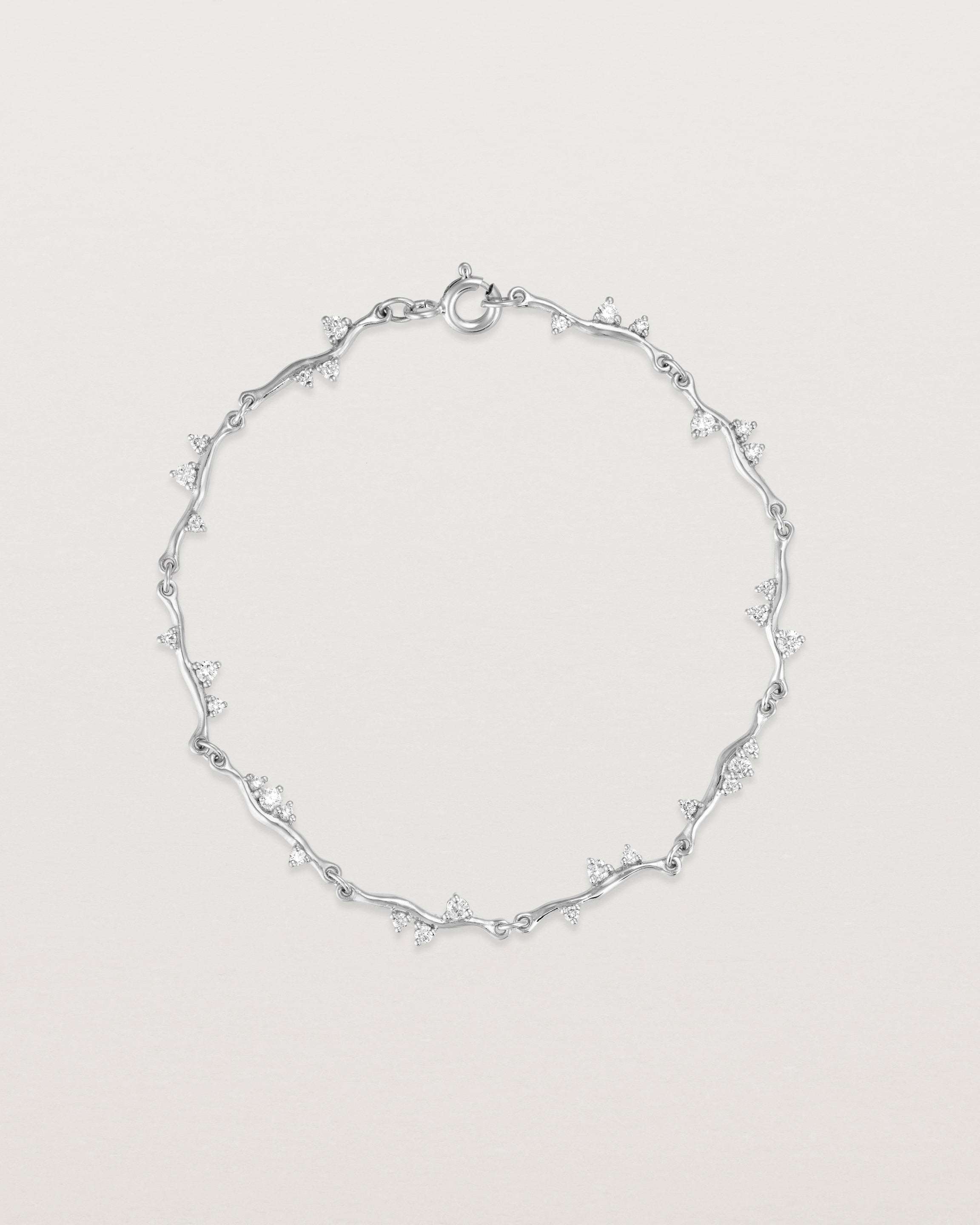 top view of ember bracelet with diamonds in white gold.