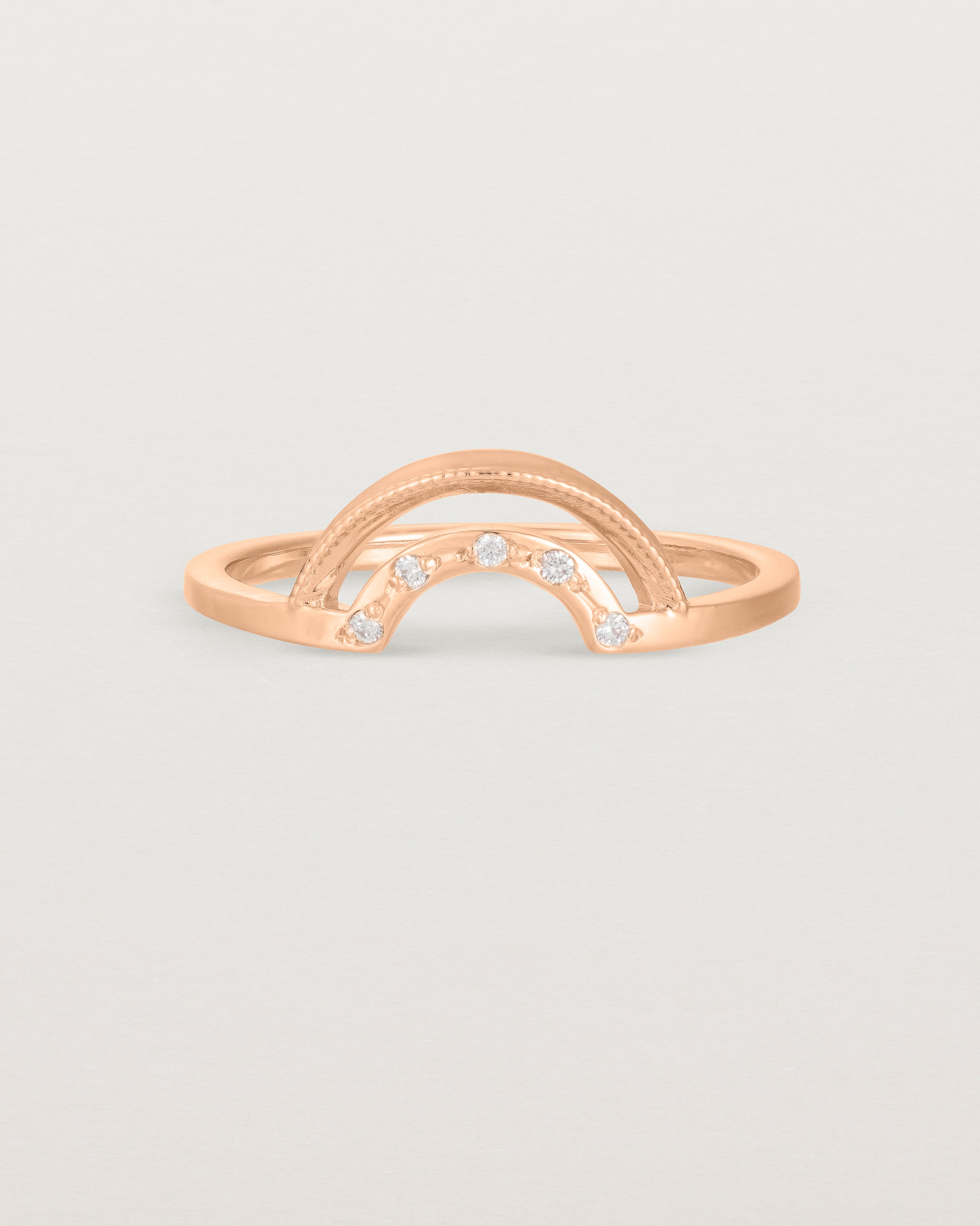 A double arc crown ring with white diamonds adoring the inner arc - crafted in rose gold. 