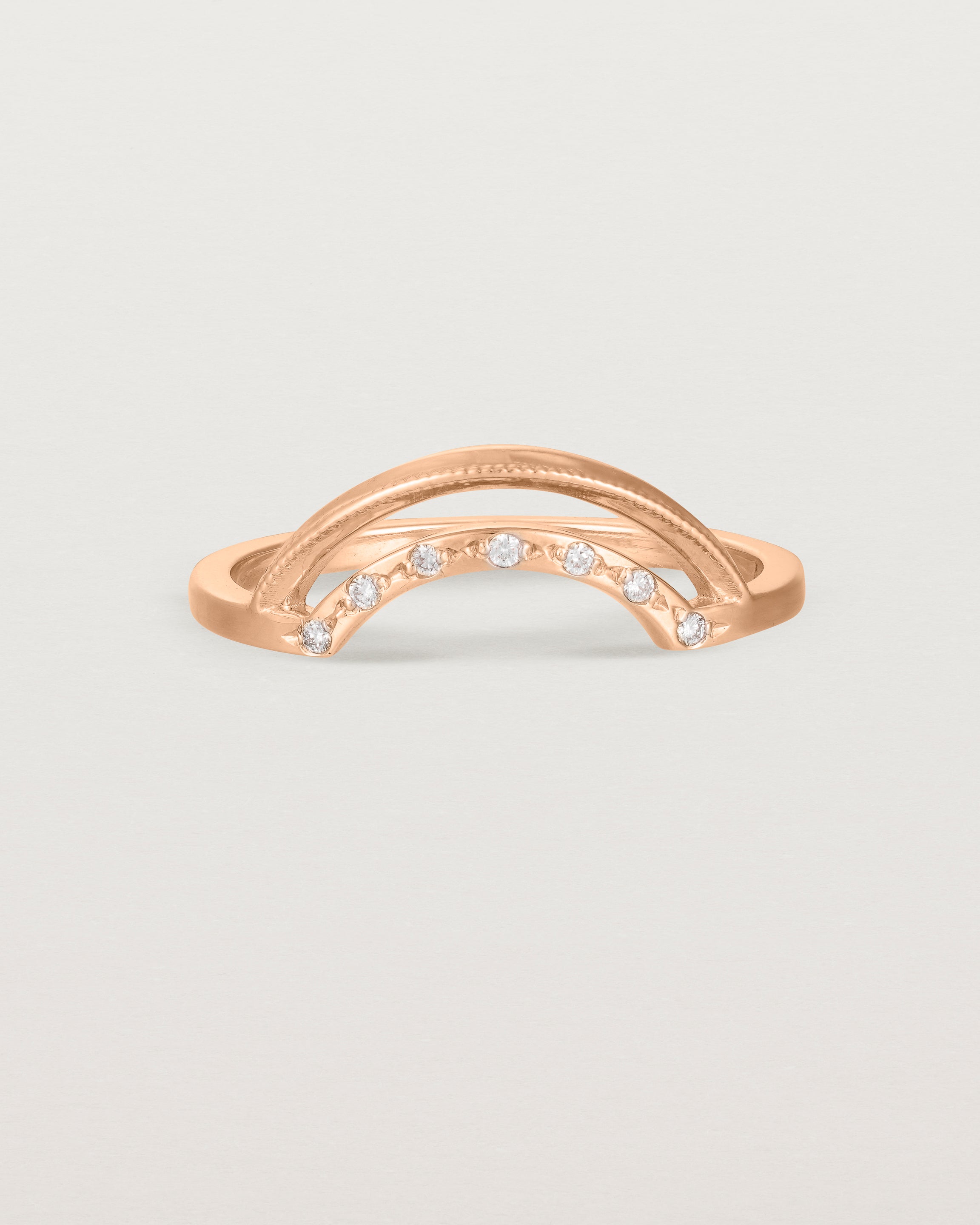Fit three of a double arc crown ring with white diamonds adoring the inner arc - crafted in rose gold.