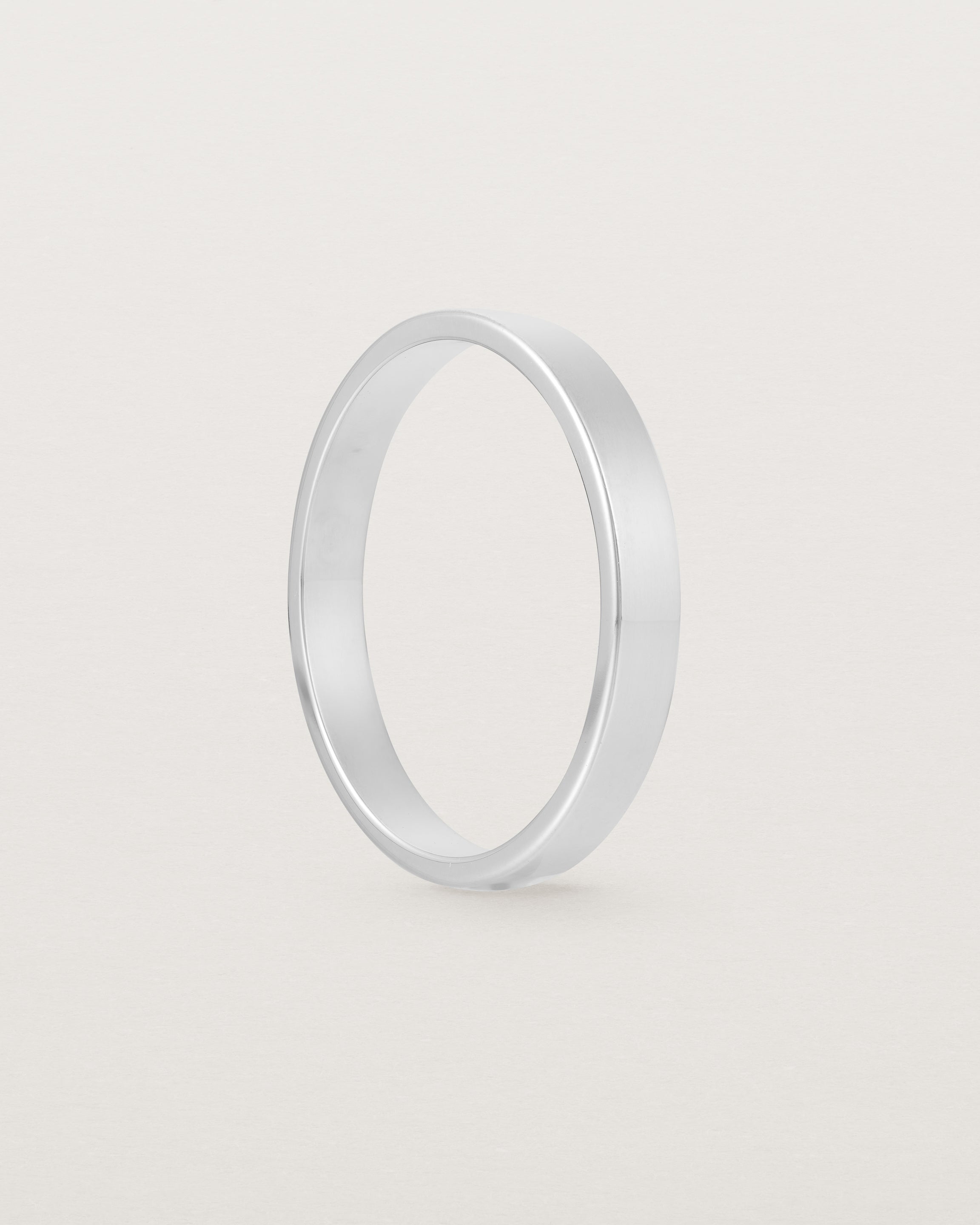 The side profile of our square, flat 3mm profile wedding band crafted in white gold