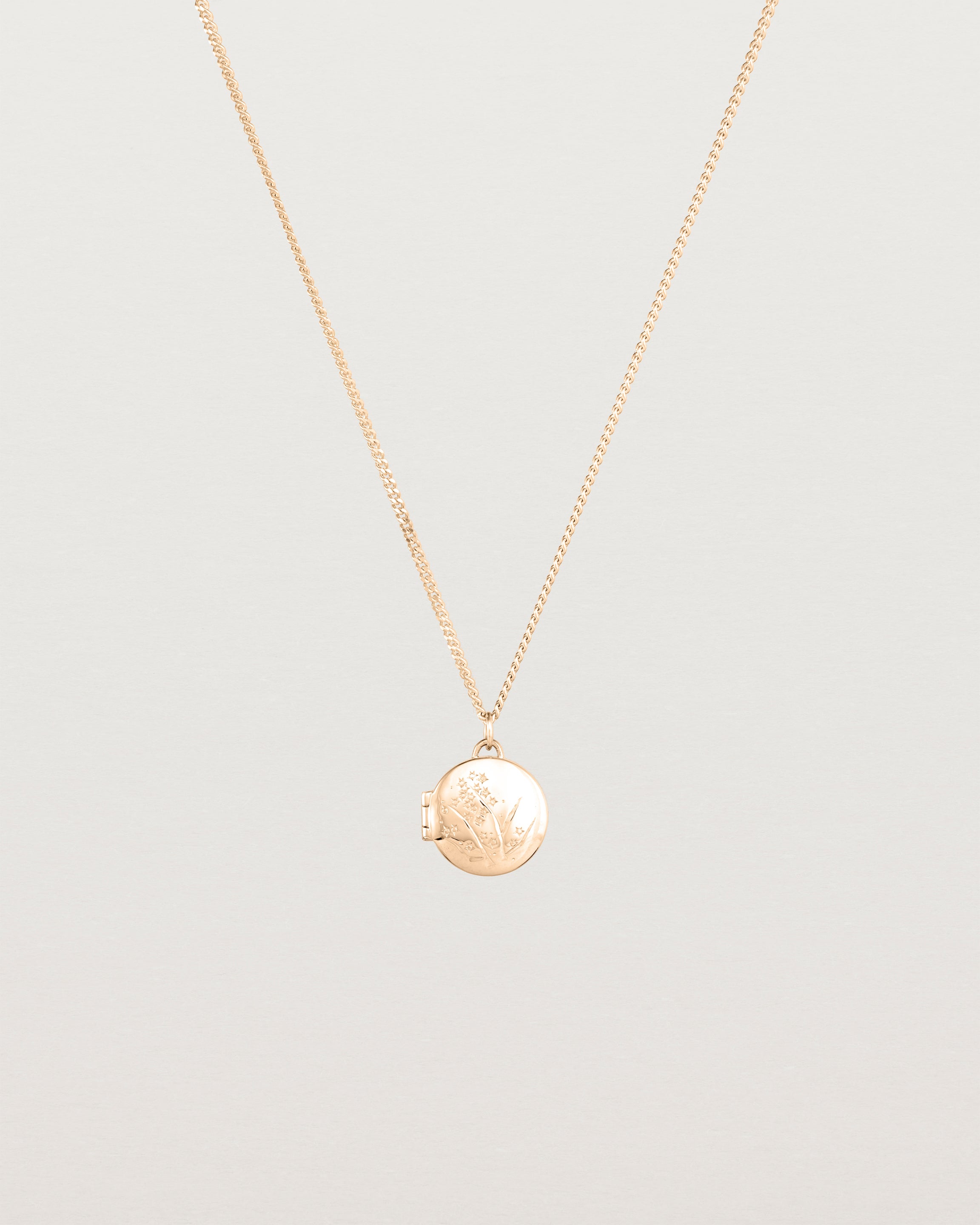 Front view of the Golden Wattle Locket in rose gold.