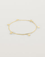 A yellow gold chain bracelet with five circle charms