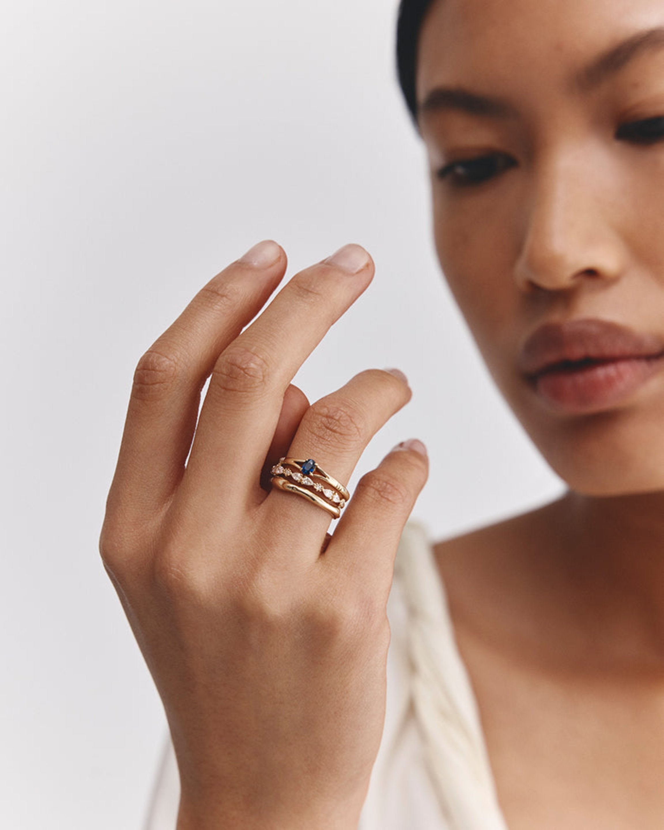 Model wears our organic wedding and stacked with our Lia Solitaire and Lena Diamond Ring.