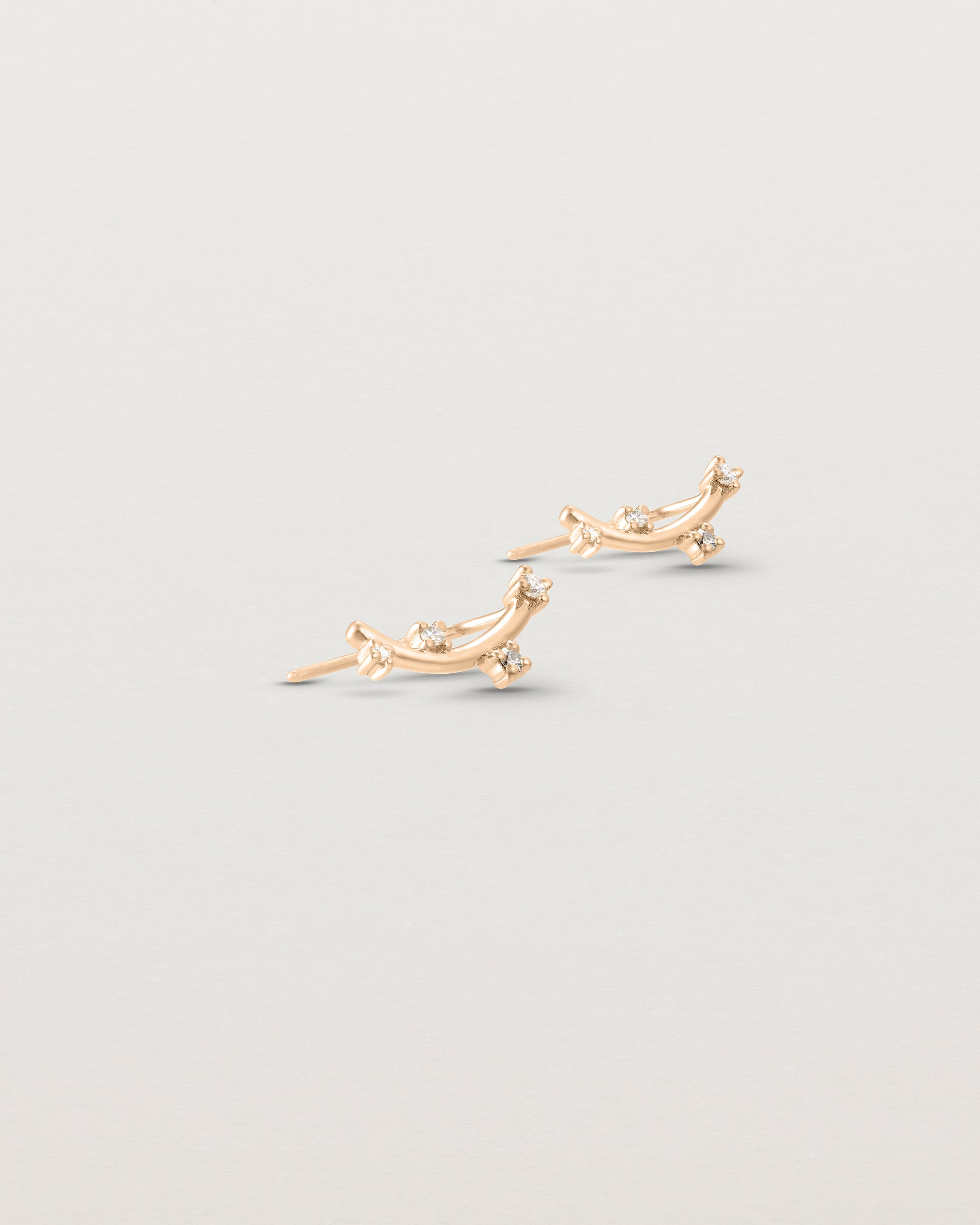 Angled view of the Lyra Earrings | Diamond in rose gold.