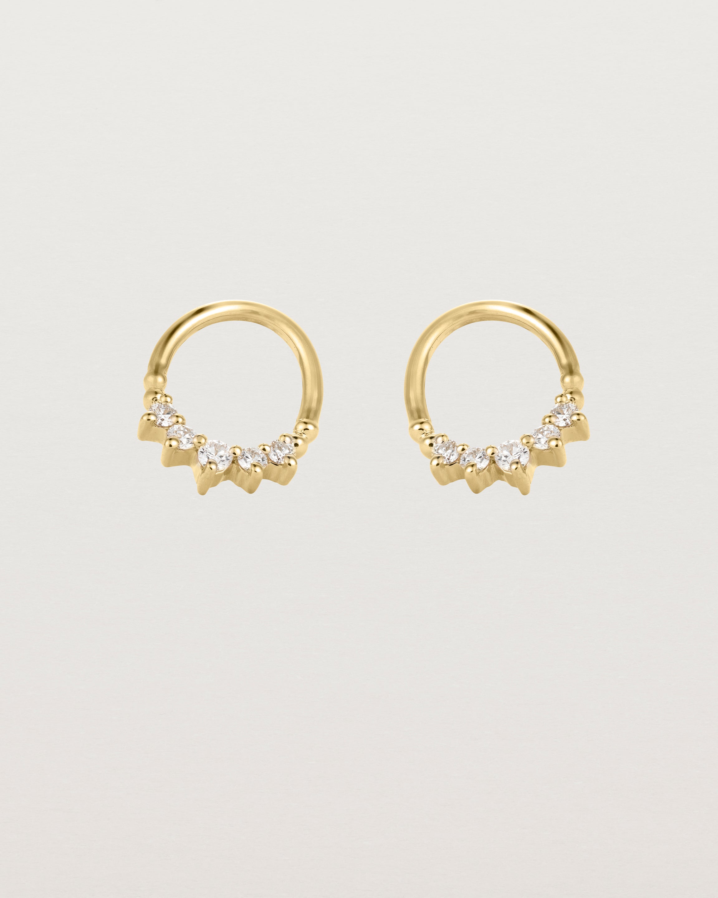 A pair of yellow gold oval studs with five white diamonds