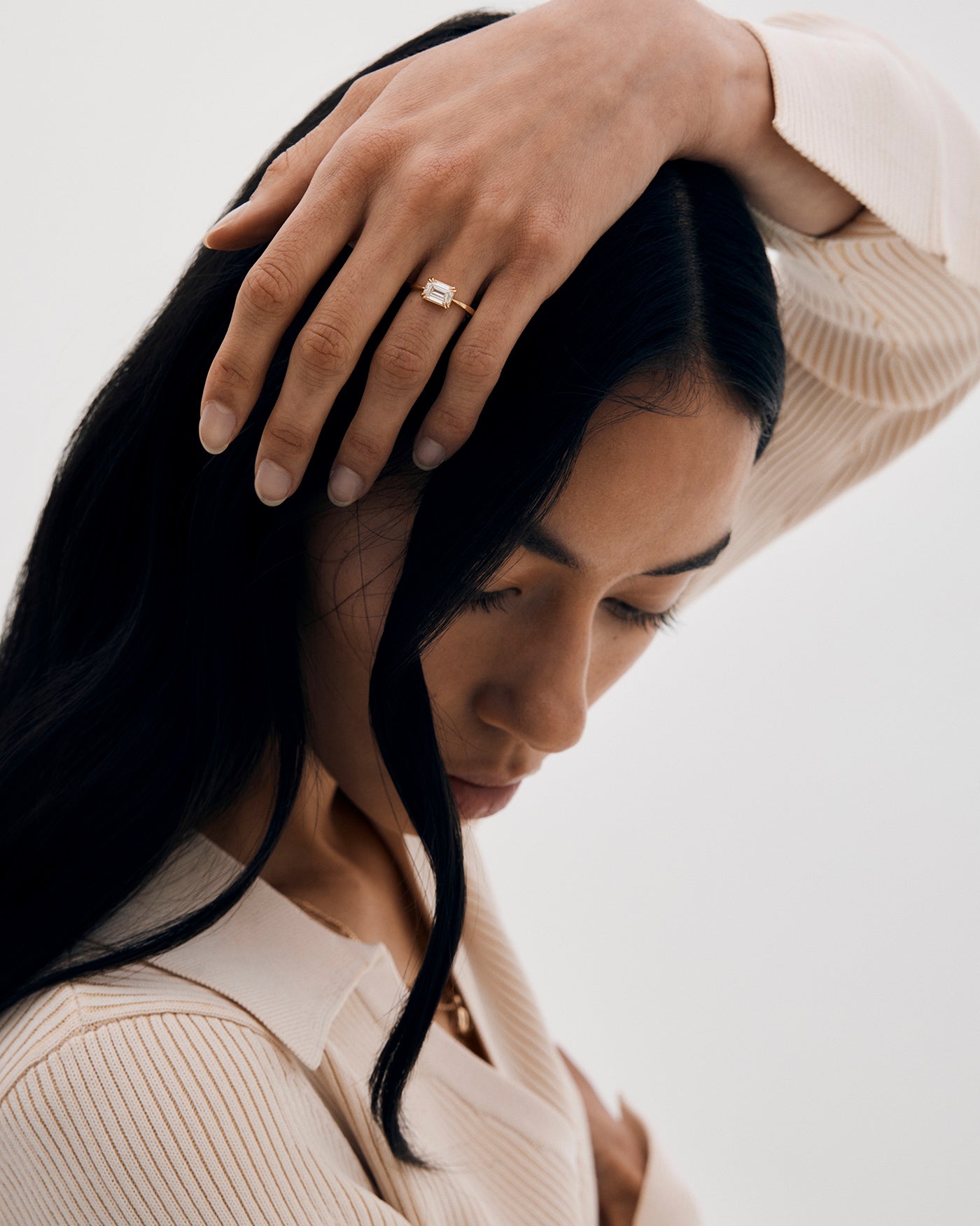 A woman wearing the Maude Solitaire ring with a Laboratory Grown Diamond