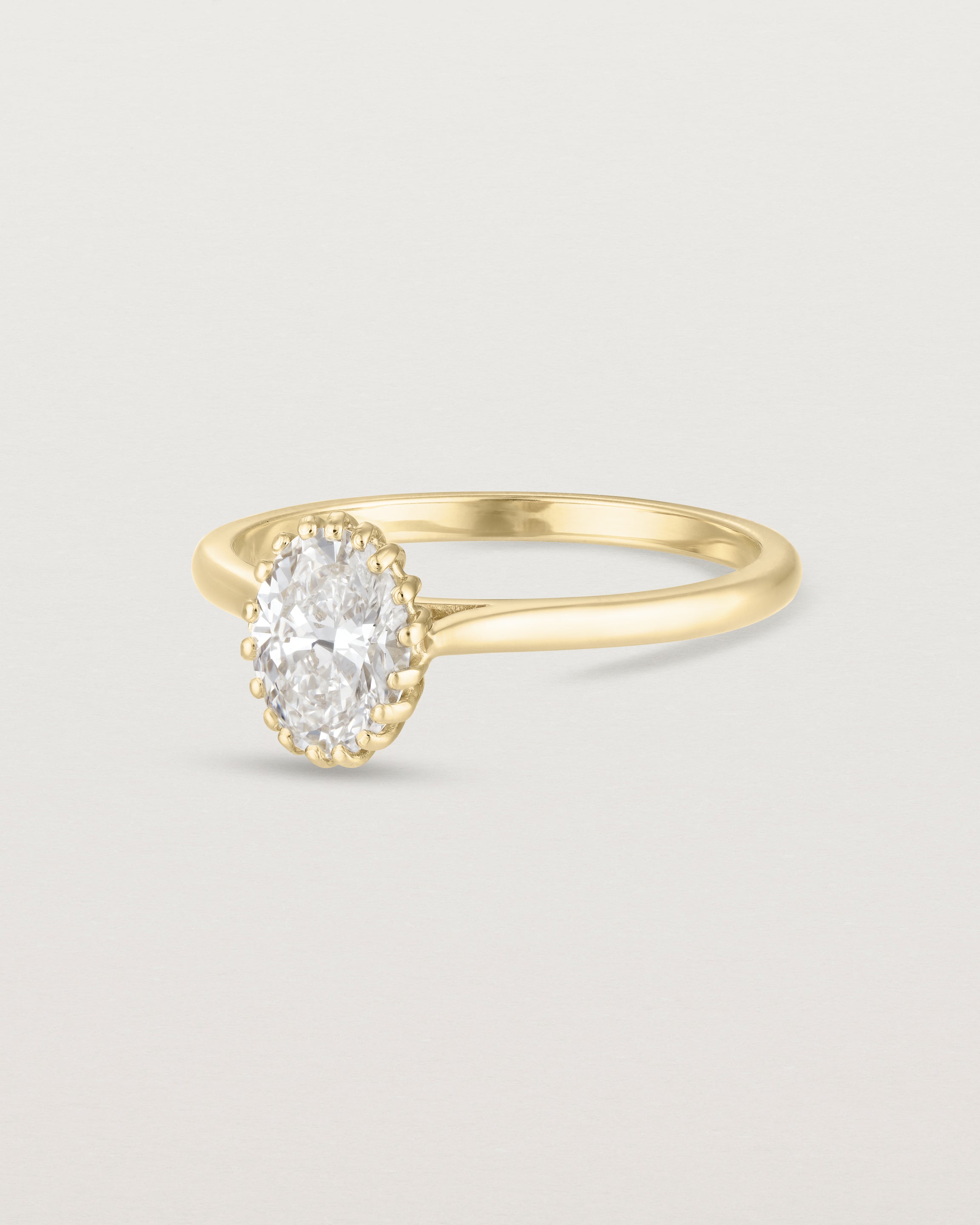 Angled view of the Meroë Oval Solitaire | Laboratory Grown Diamond in yellow gold.